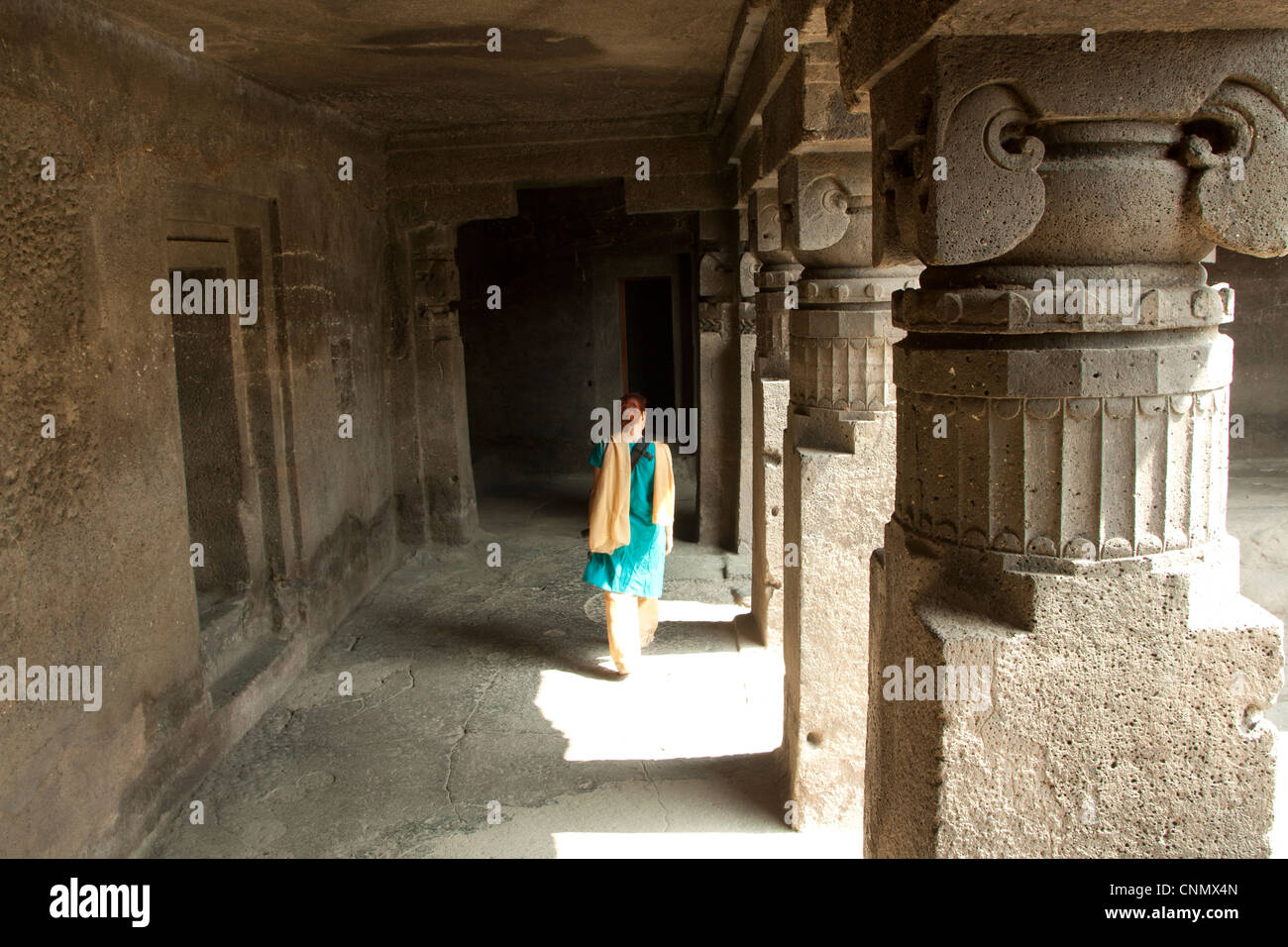 Woman wearing Sari wandering the Ellora caves, India, travel Stock Photo