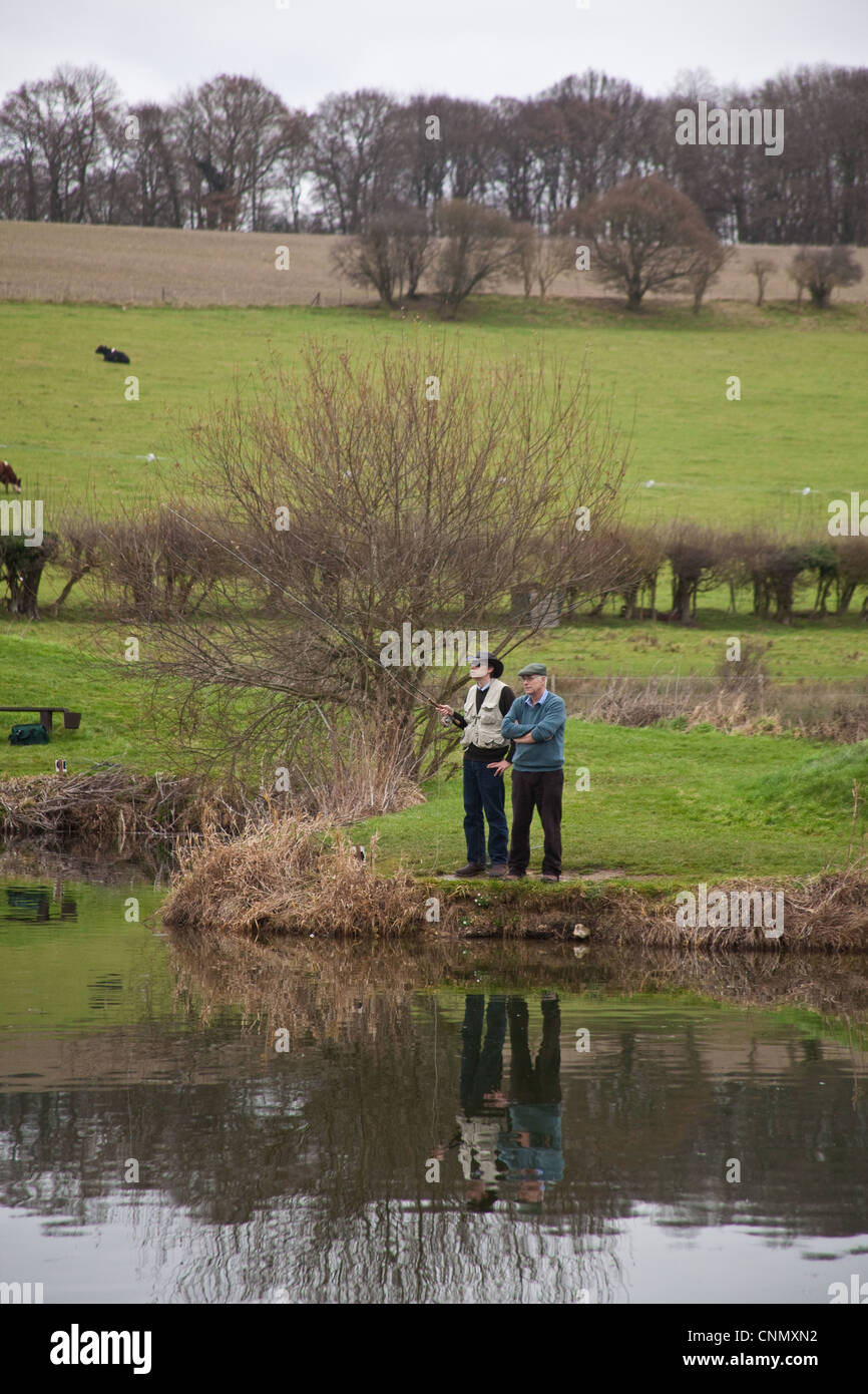 Fly fishermen fishing at Moorhen Trout Fishery, Warnford, Hampshire