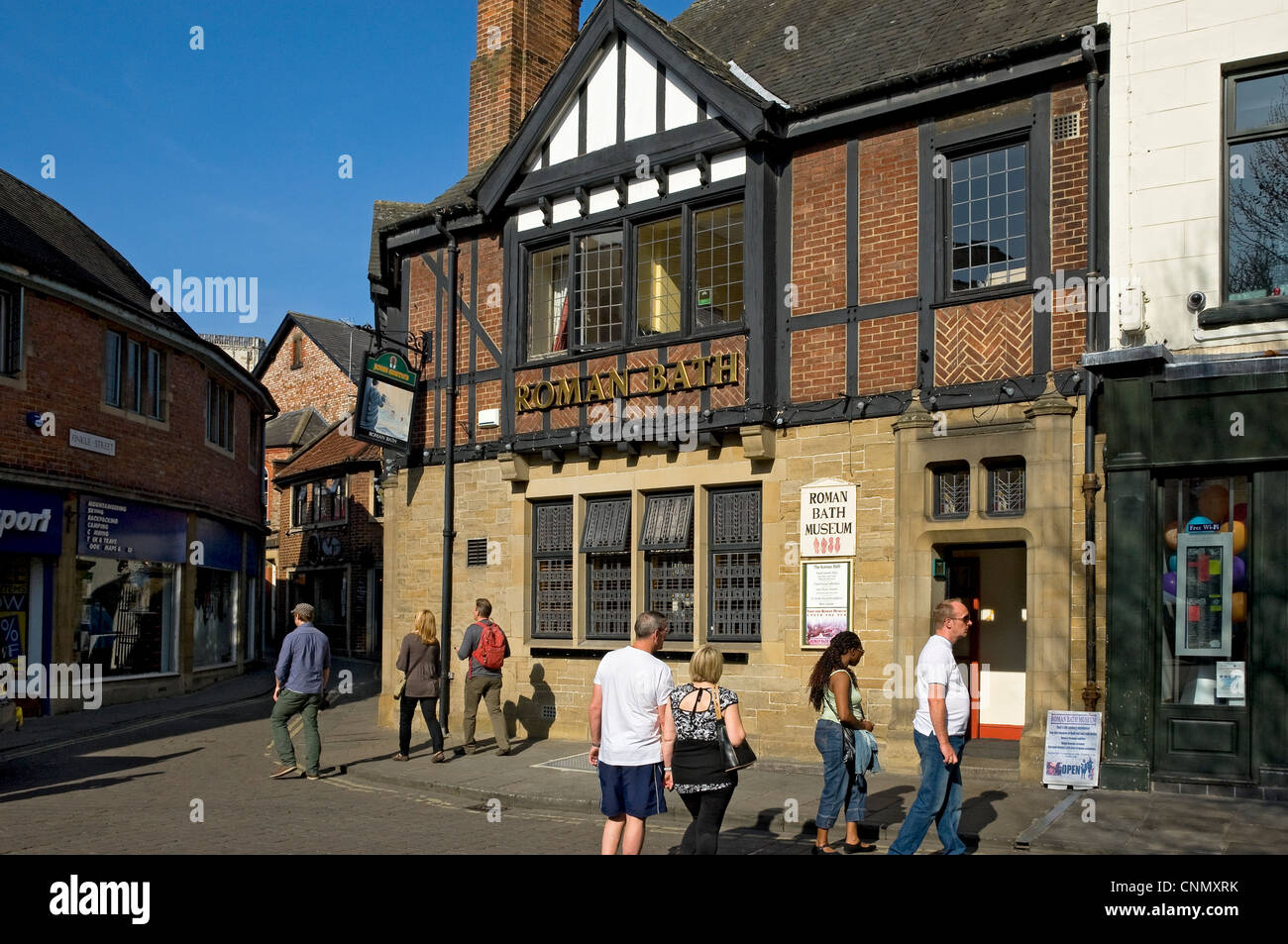 People tourists visitors outside The Roman Bath pub St Sampson's Square York City Town Centre North Yorkshire England UK United Kingdom Great Britain Stock Photo