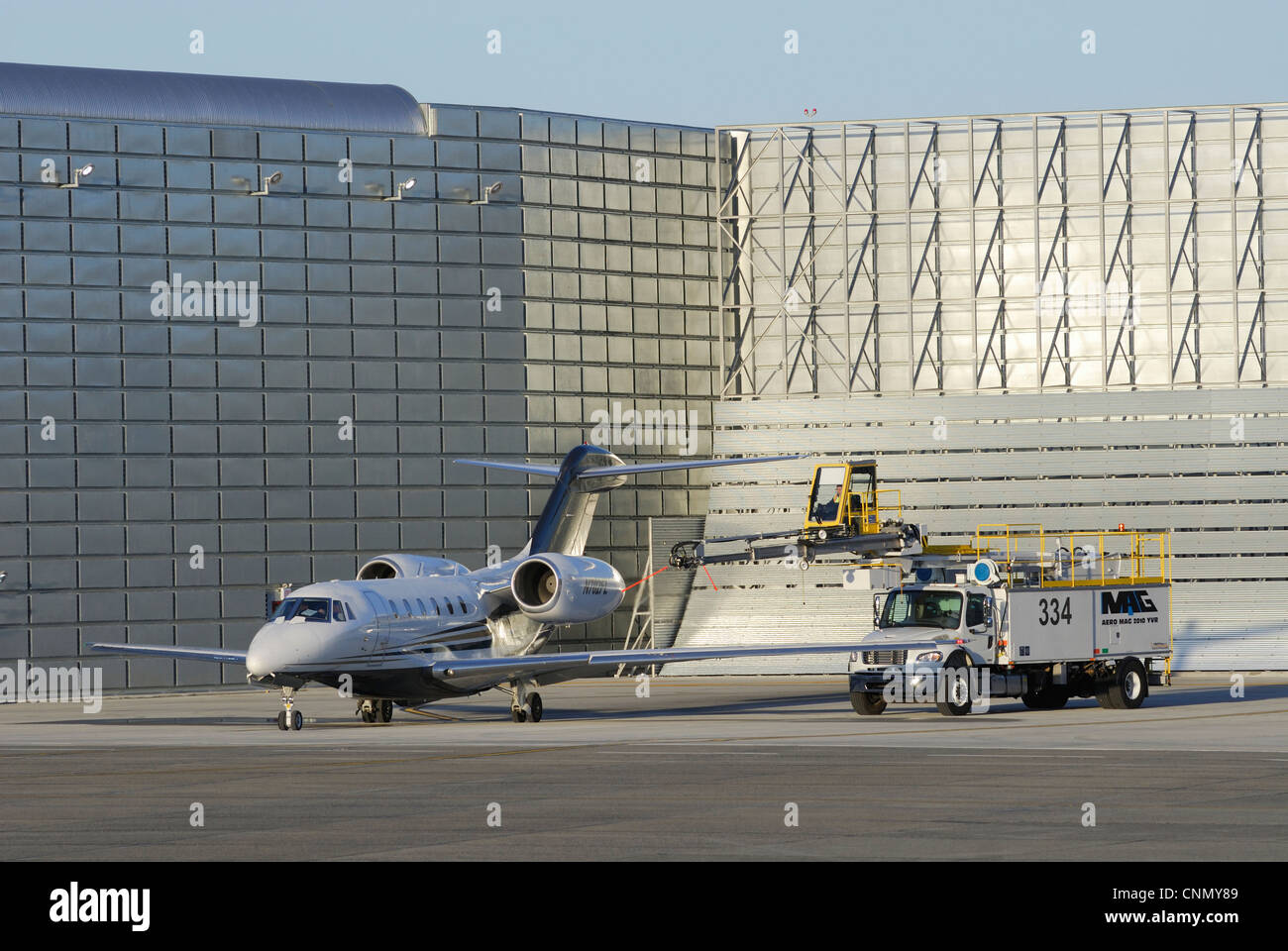 Cessna Citation X twin jet being deiced in a Ground Run-up Enclosure at the Vancouver international Airport Stock Photo