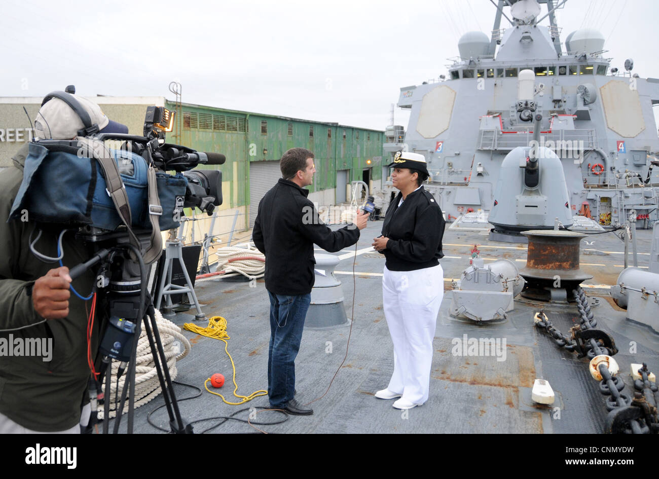 Cmdr. Monika Stoker, commanding officer of the guided-missile destroyer USS Mitscher (DDG 57) and the first African-American female to command an Aegis-class destroyer, speaks with Scott Satchfield of the New Orleans CBS affiliate, WWL Channel 4. The War of 1812 Bicentennial Commemoration in New Orleans is part of a series of city visits by the Navy, Coast Guard, Marine Corps and Operation Sail beginning in April 2012 and concluding in 2015. New Orleans is the first and the last city visit in the series. Stock Photo