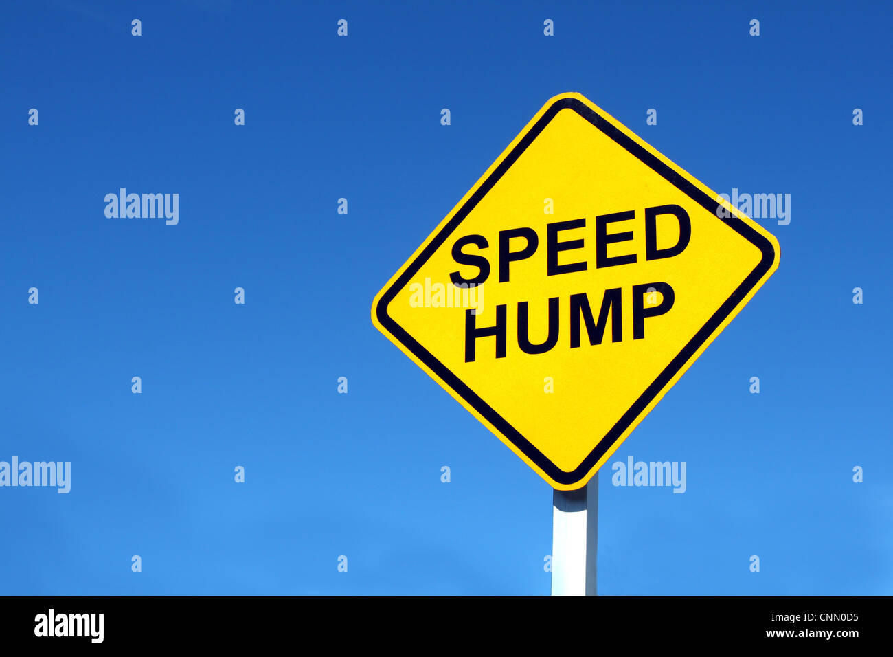 Speed humps road sign isolated on a clear blue sky Stock Photo - Alamy