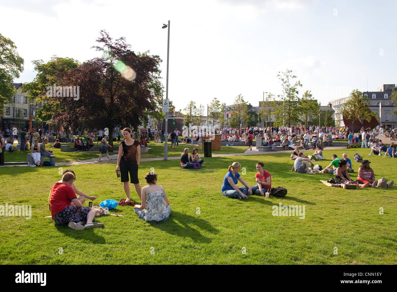 People enjoying the sun in Eyre Square Galway Stock Photo