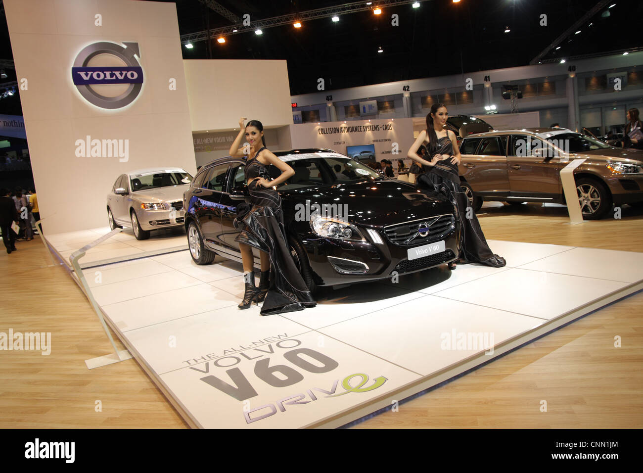 Presenters posing with Volvo car at Thailand Motor Show 2012 Stock Photo