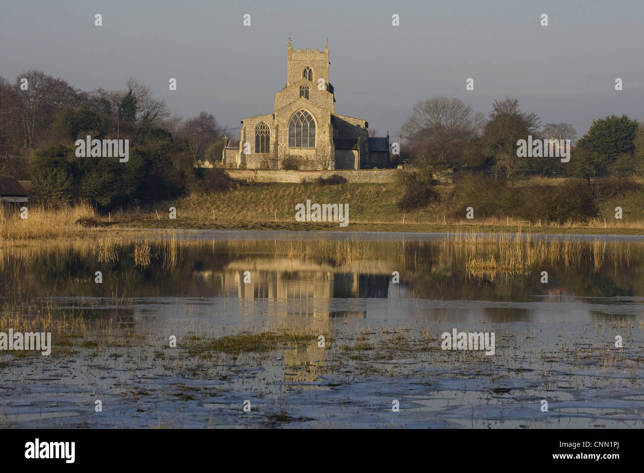 View across flooded grazing marsh towards church, St. Mary's Church ...