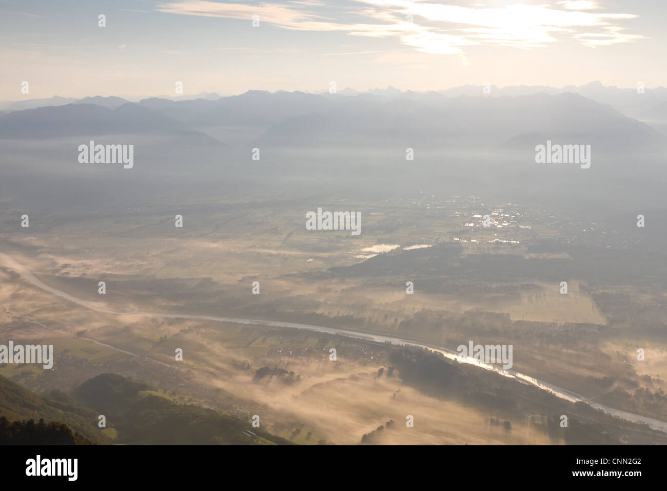 view over the border plain of Switzerland and Liechtenstein in morning mist veil with river Rhine Stock Photo