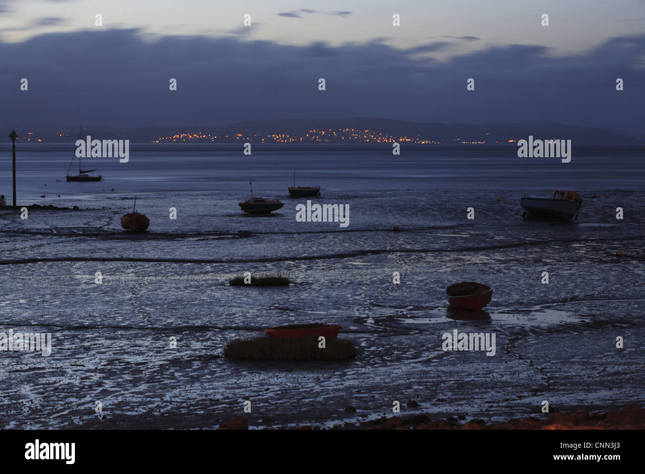 View boats intertidal mudflats habitat during low tide night looking towards Grange-over-sands Cumbria Morecambe Morecambe Bay Stock Photo