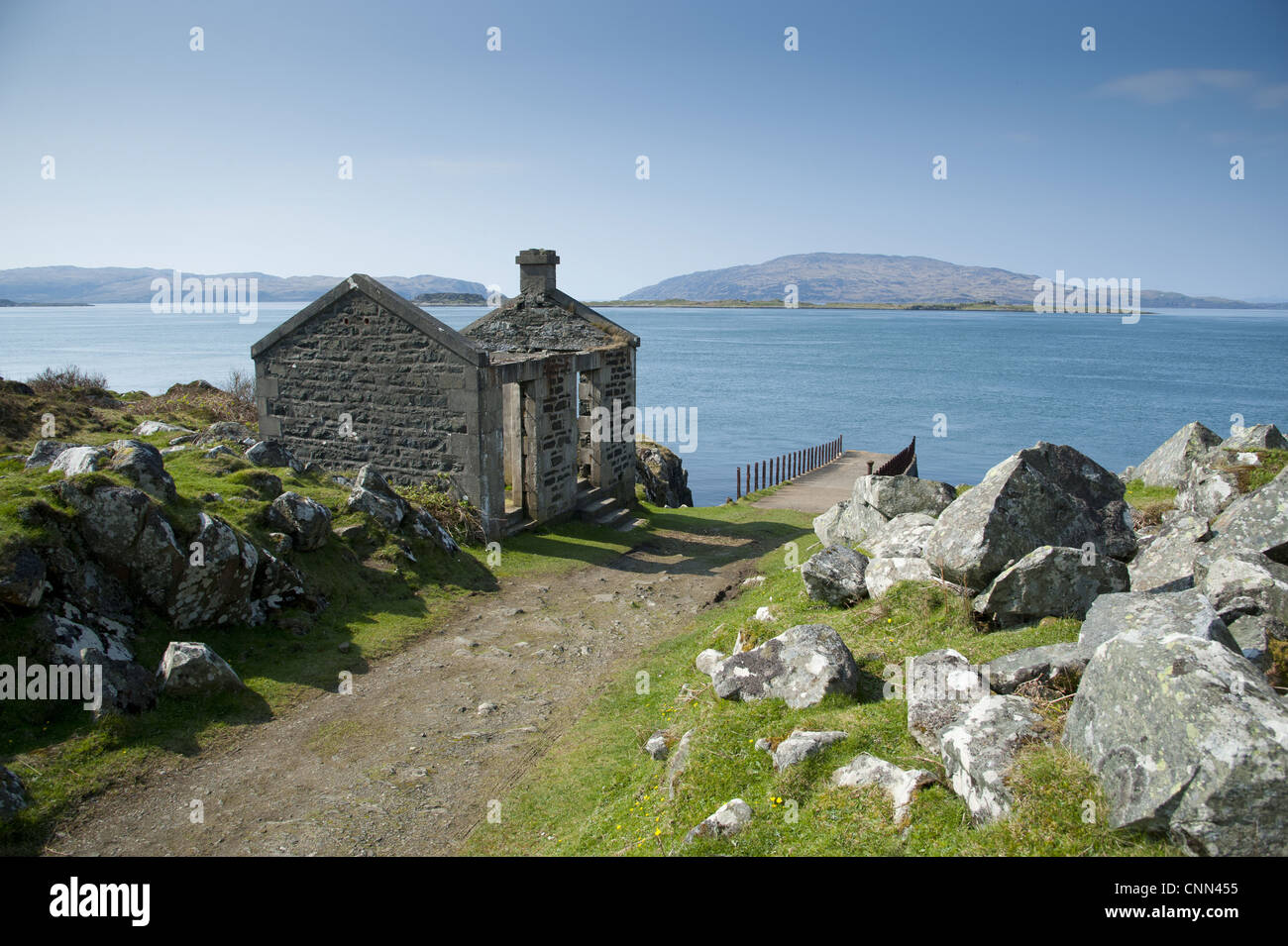 View of ruined ticket office, pier and coastline, Craignish, Argyll and Bute, Scotland, april Stock Photo