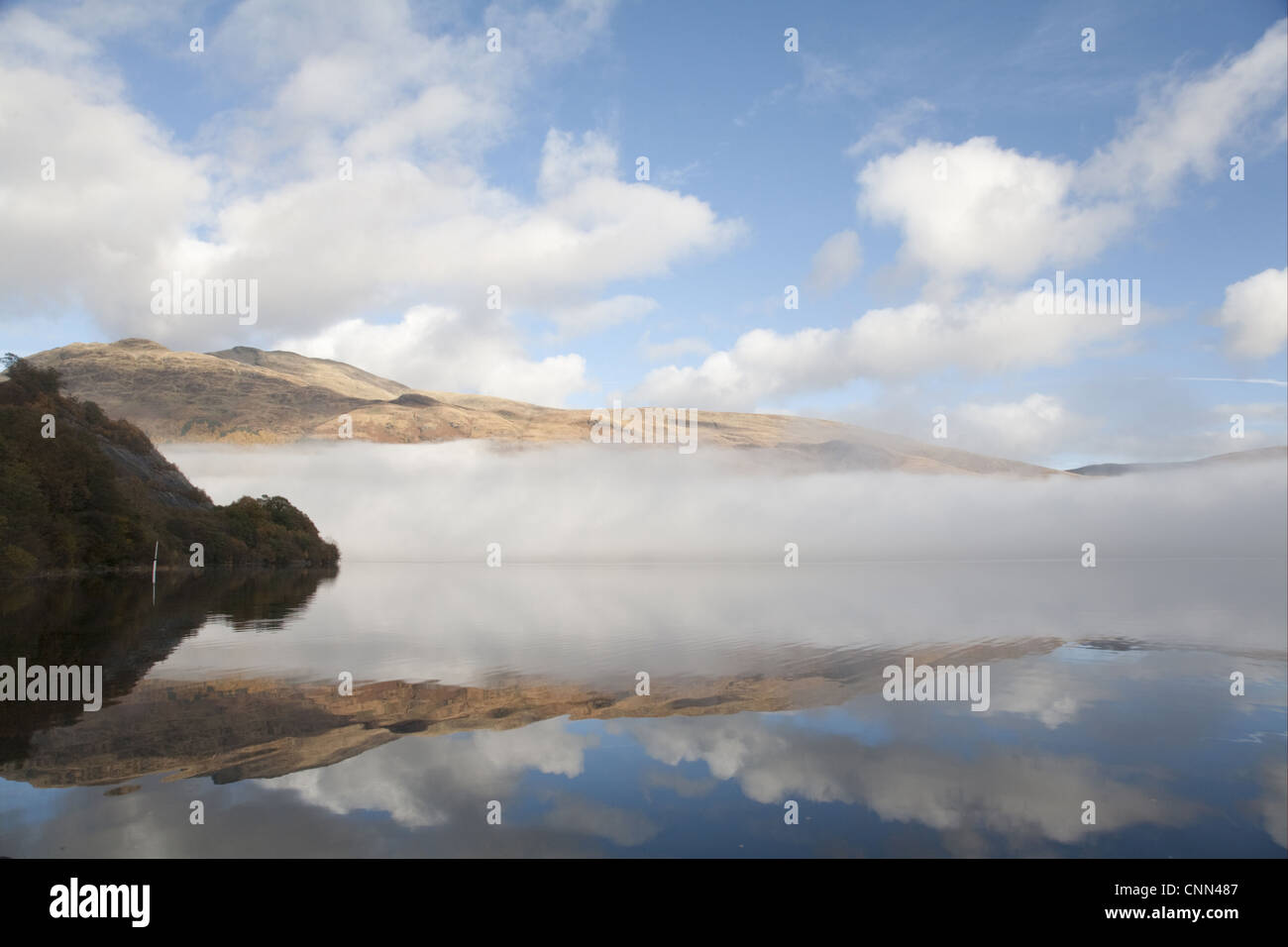 View of freshwater loch with mist, Loch Lomond, Argyll and Bute, Scotland, october Stock Photo