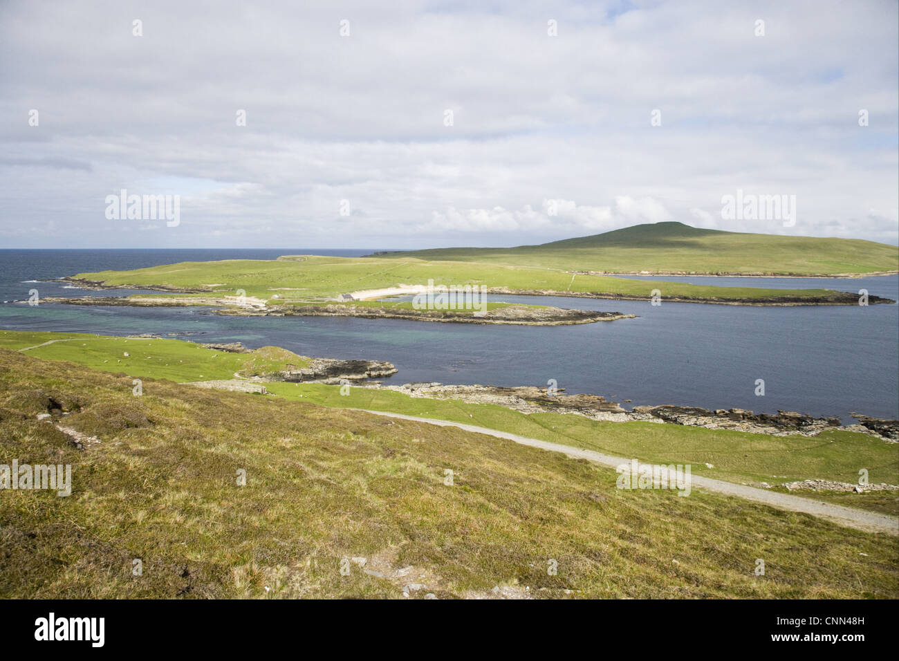 View coastline distant wardens house ferry crossing Noss Bressay across Noss Sound Shetland Islands Scotland june Stock Photo