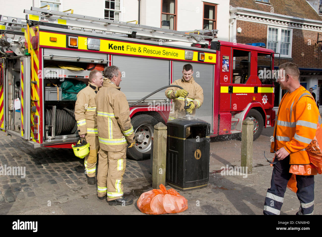 Fire Brigade on Call City Centre small fire in rubbish bin. Emergency Services Stock Photo