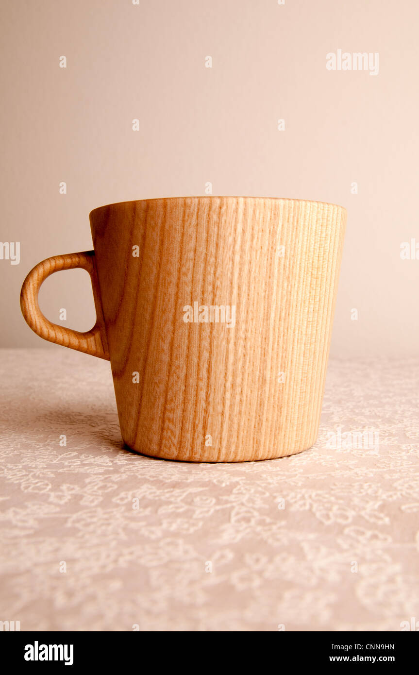 Wooden Mug on Tablecloth. Stock Photo