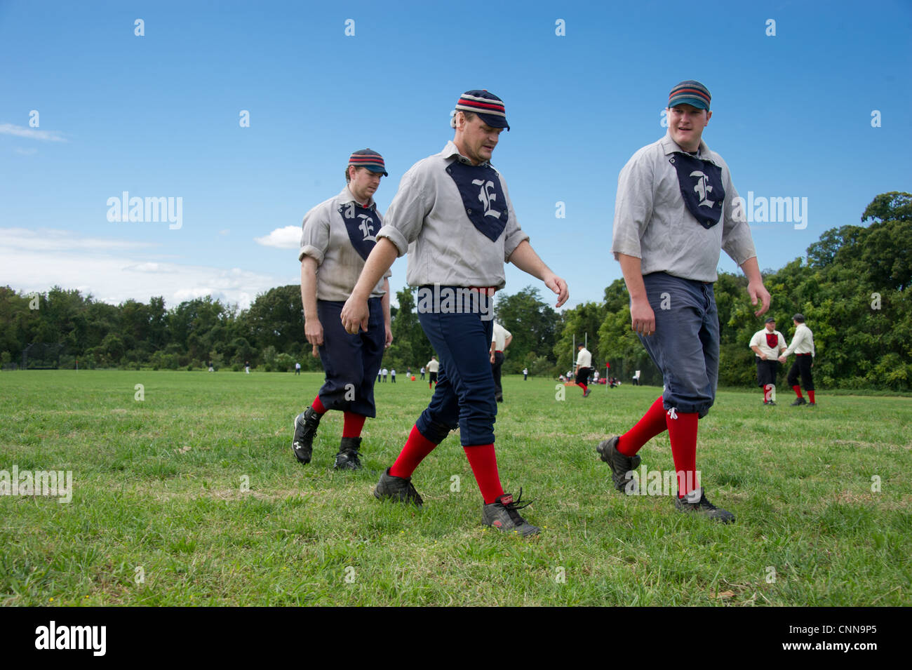 Teammates walking off the field dressed in vintage uniform playing vintage baseball Stock Photo