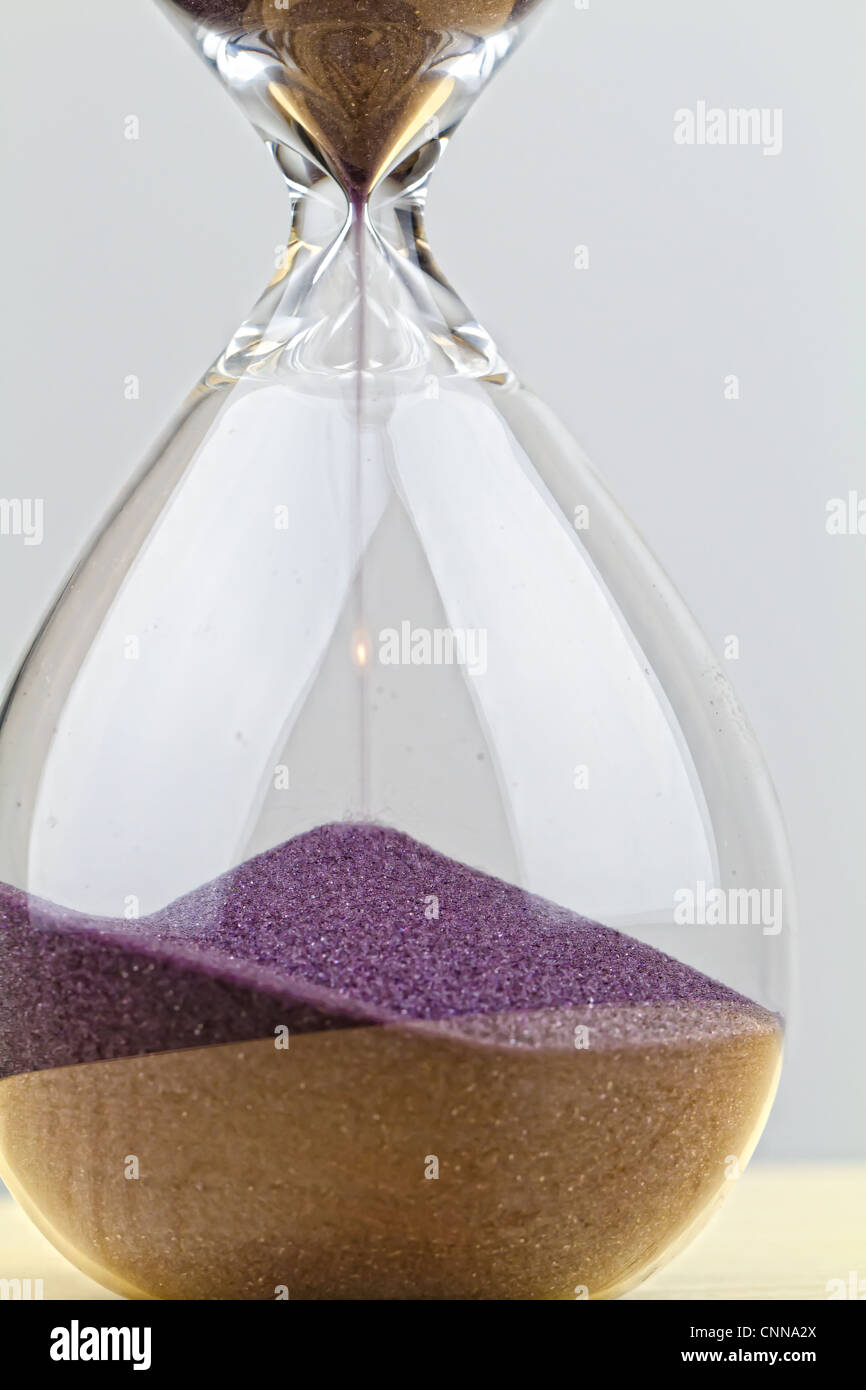 hourglass with running sand - time is running Stock Photo
