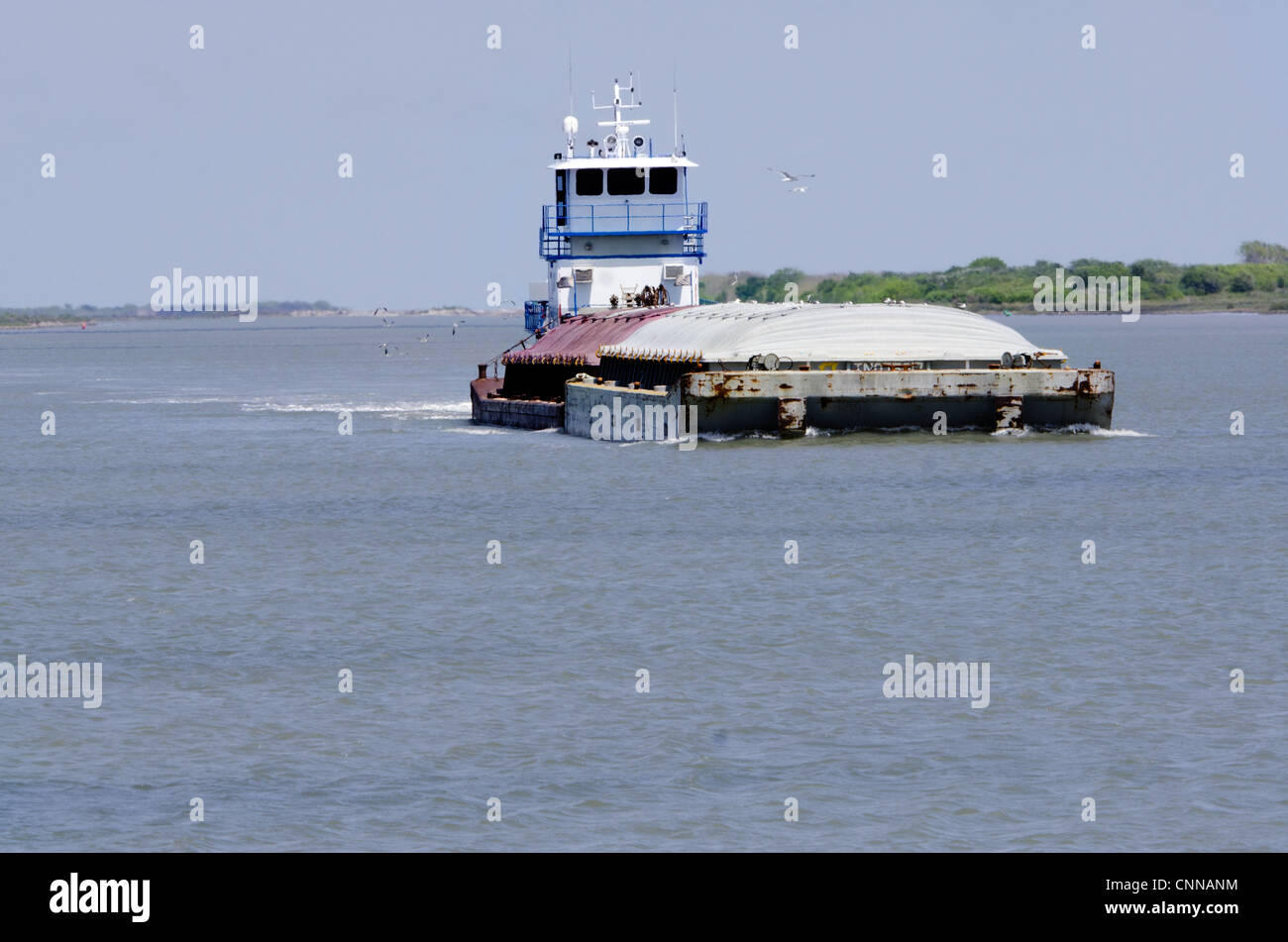 A barge motors on the Gulf of Mexico, barrier islands off of Fulton, Texas. Usa Stock Photo