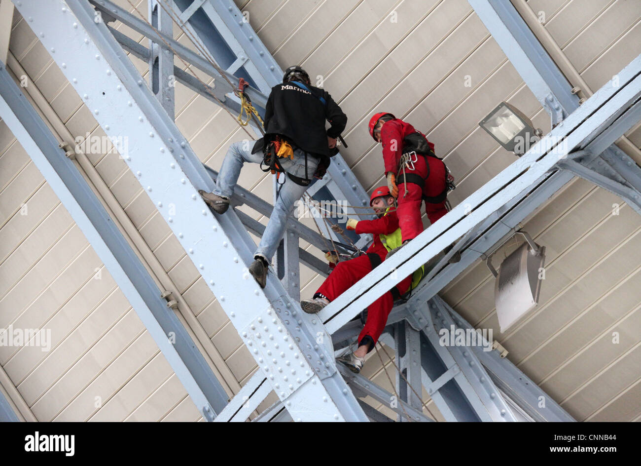 Workmen in the roof at Saint  Pancras Station in London Stock Photo