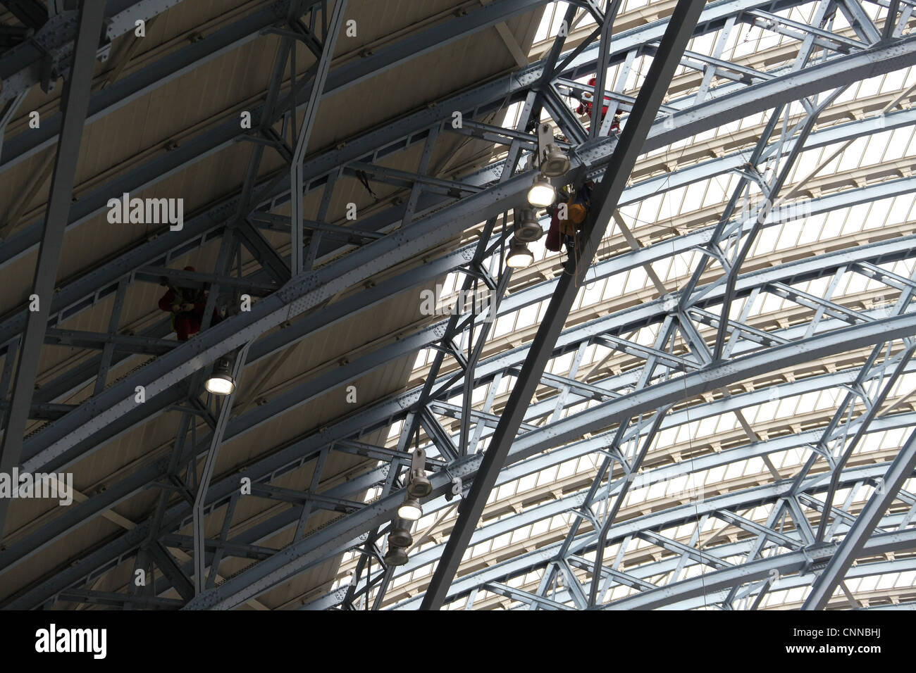 Workmen in the roof at Saint  Pancras Station in London Stock Photo