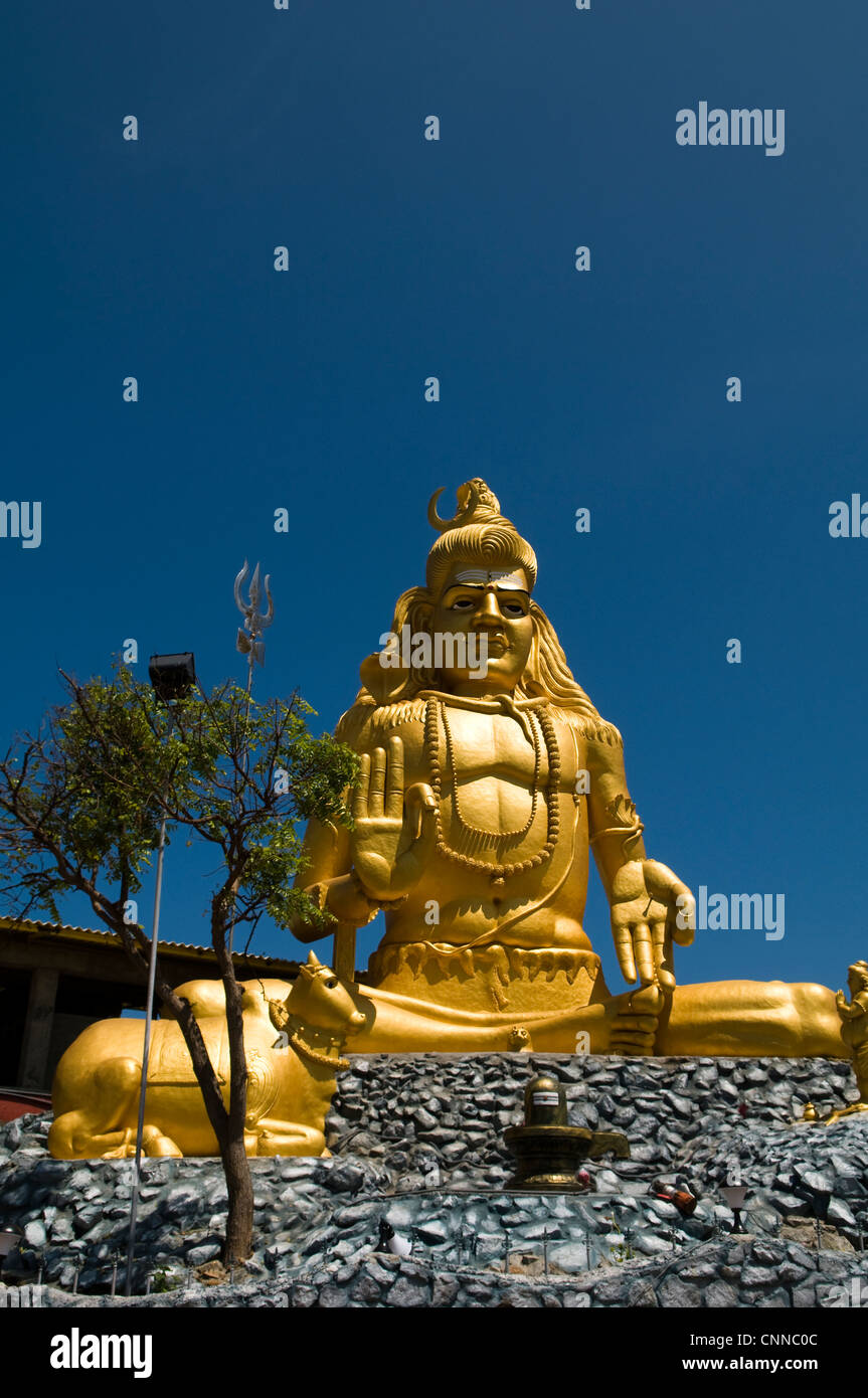 A big Golden Shiva statue at the entrance to the Koneswaram temple on top of Swami Rock in Trincomalee, Sri Lanka. Stock Photo