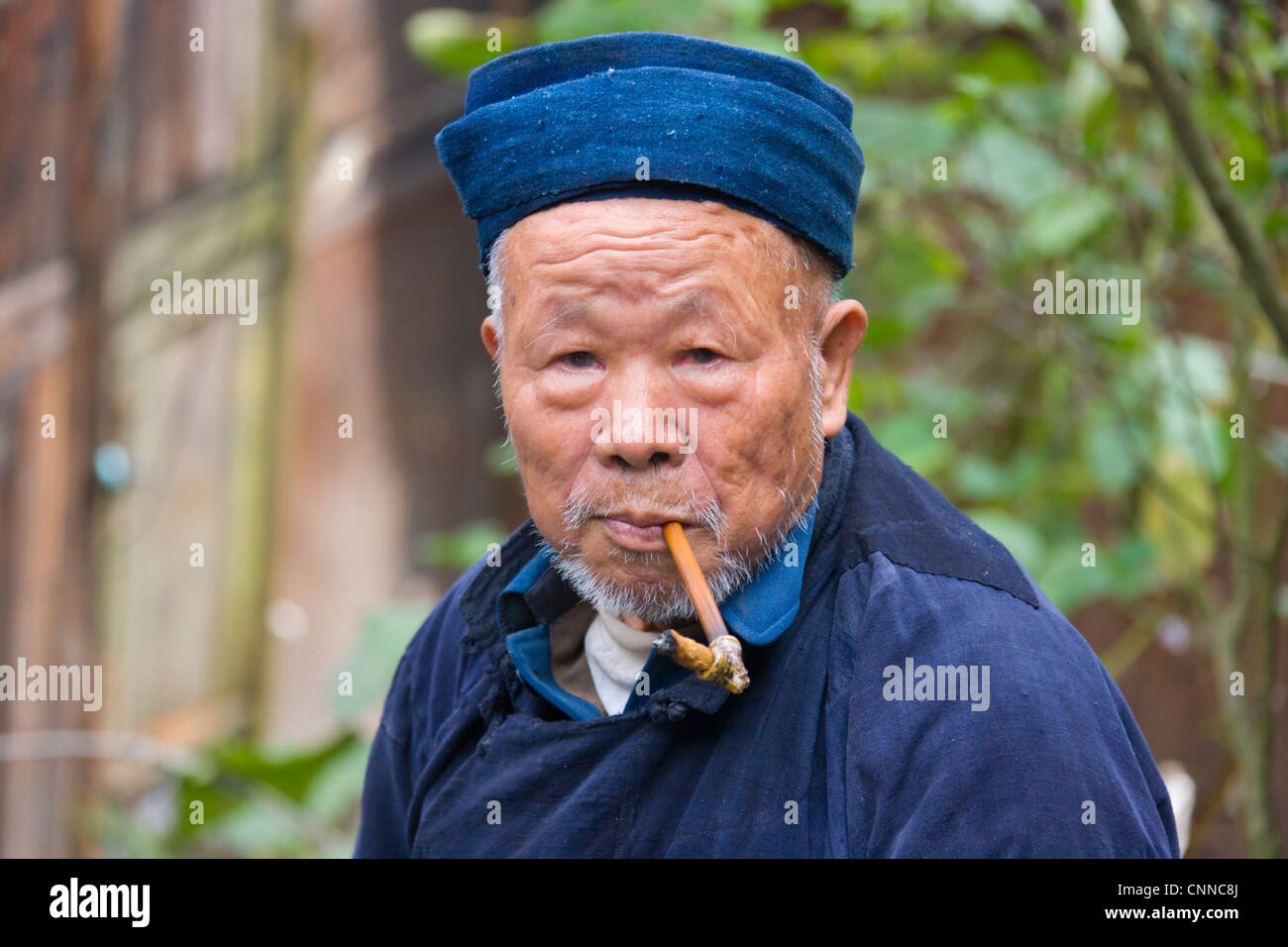 Langde Miao man smoking a pipe, Kaili, Guizhou, China Stock Photo