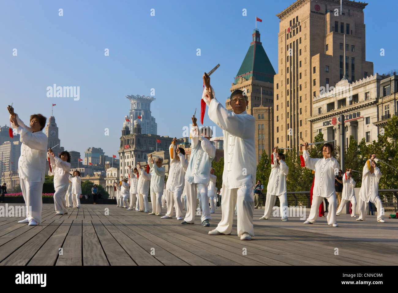 People practicing Taiji with sword on the Bund in the morning, Shanghai, China Stock Photo