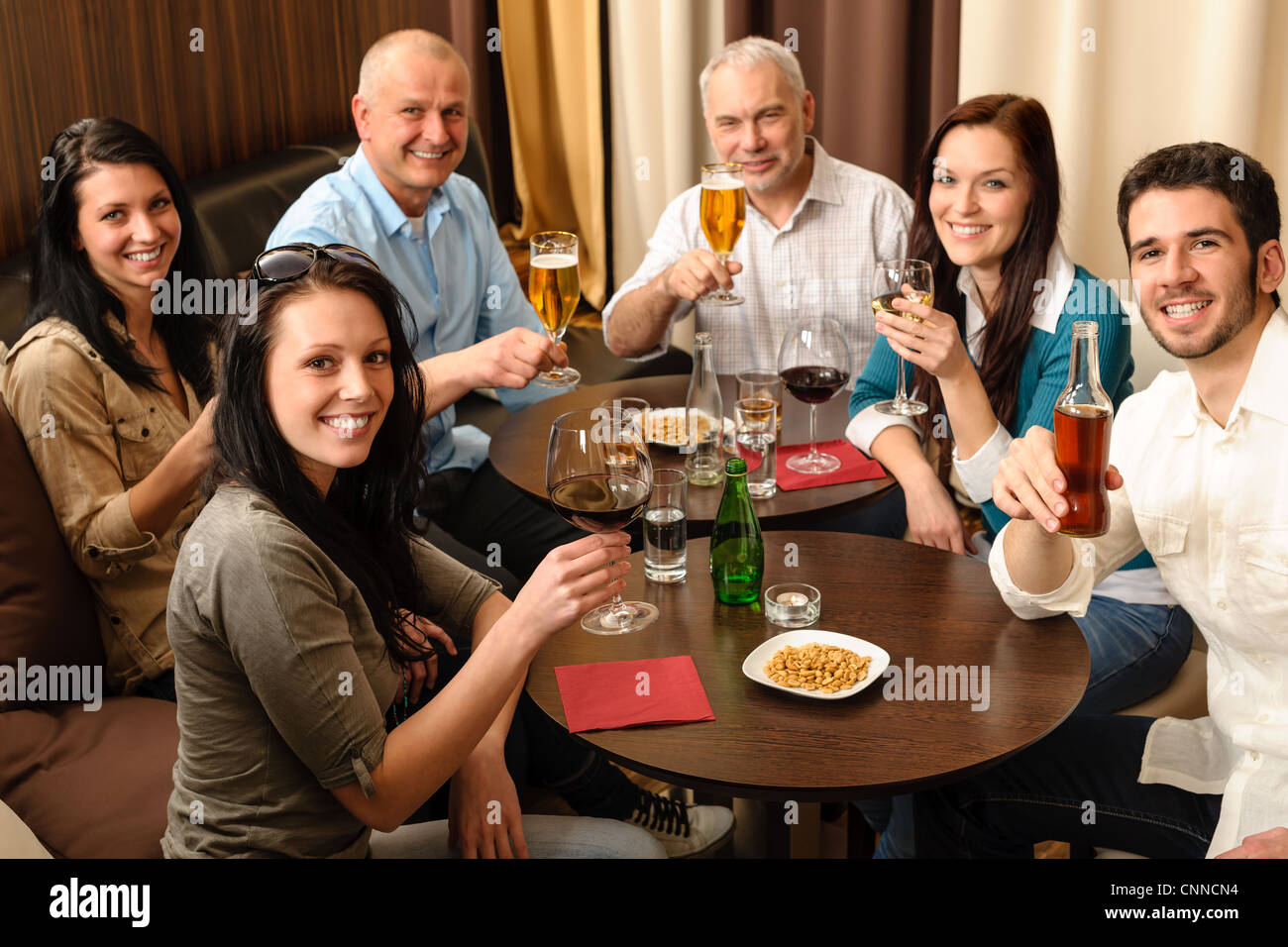Drink after work happy colleagues having fun at fancy restaurant Stock Photo
