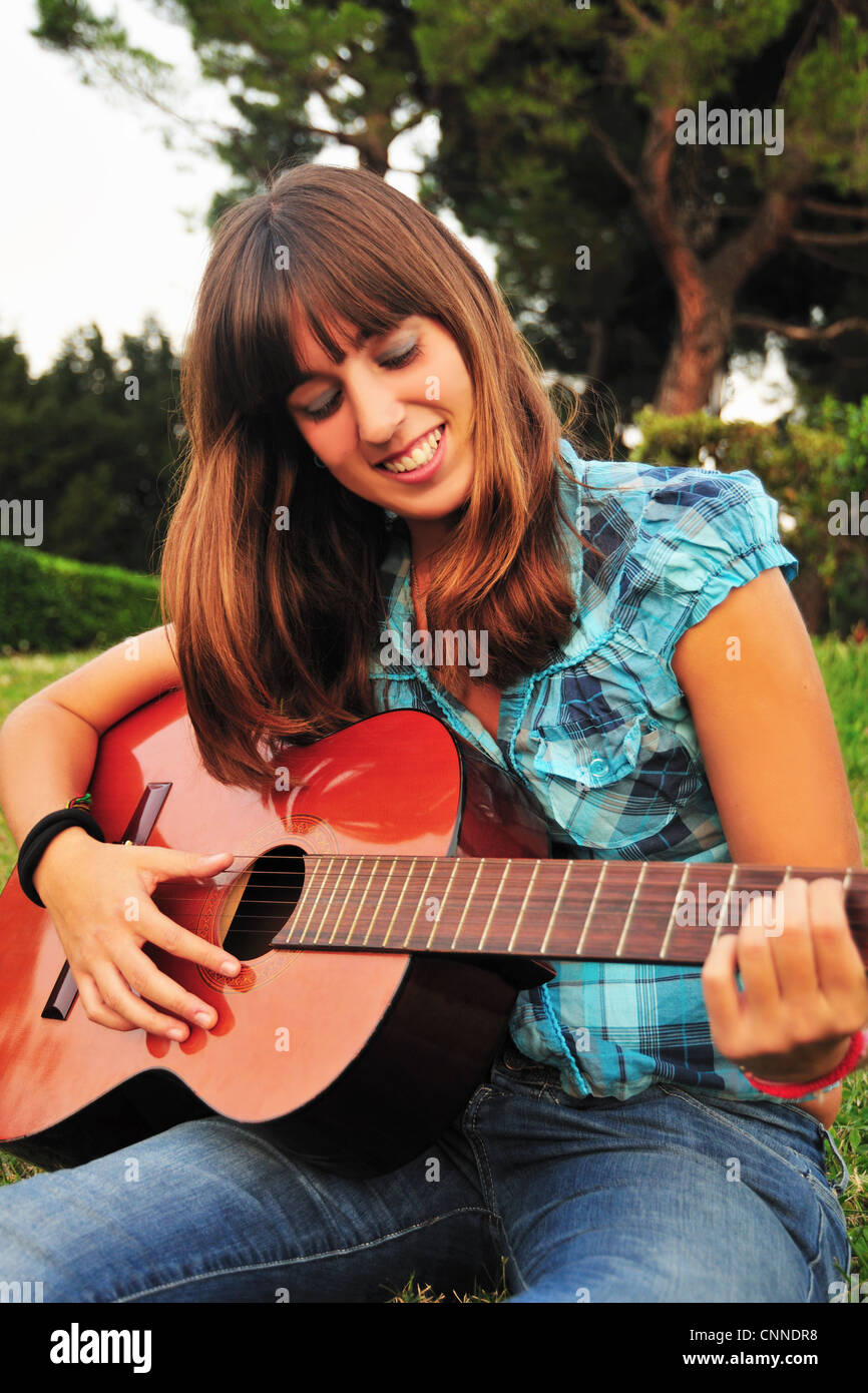 Teenage girl playing guitar Stock Photo