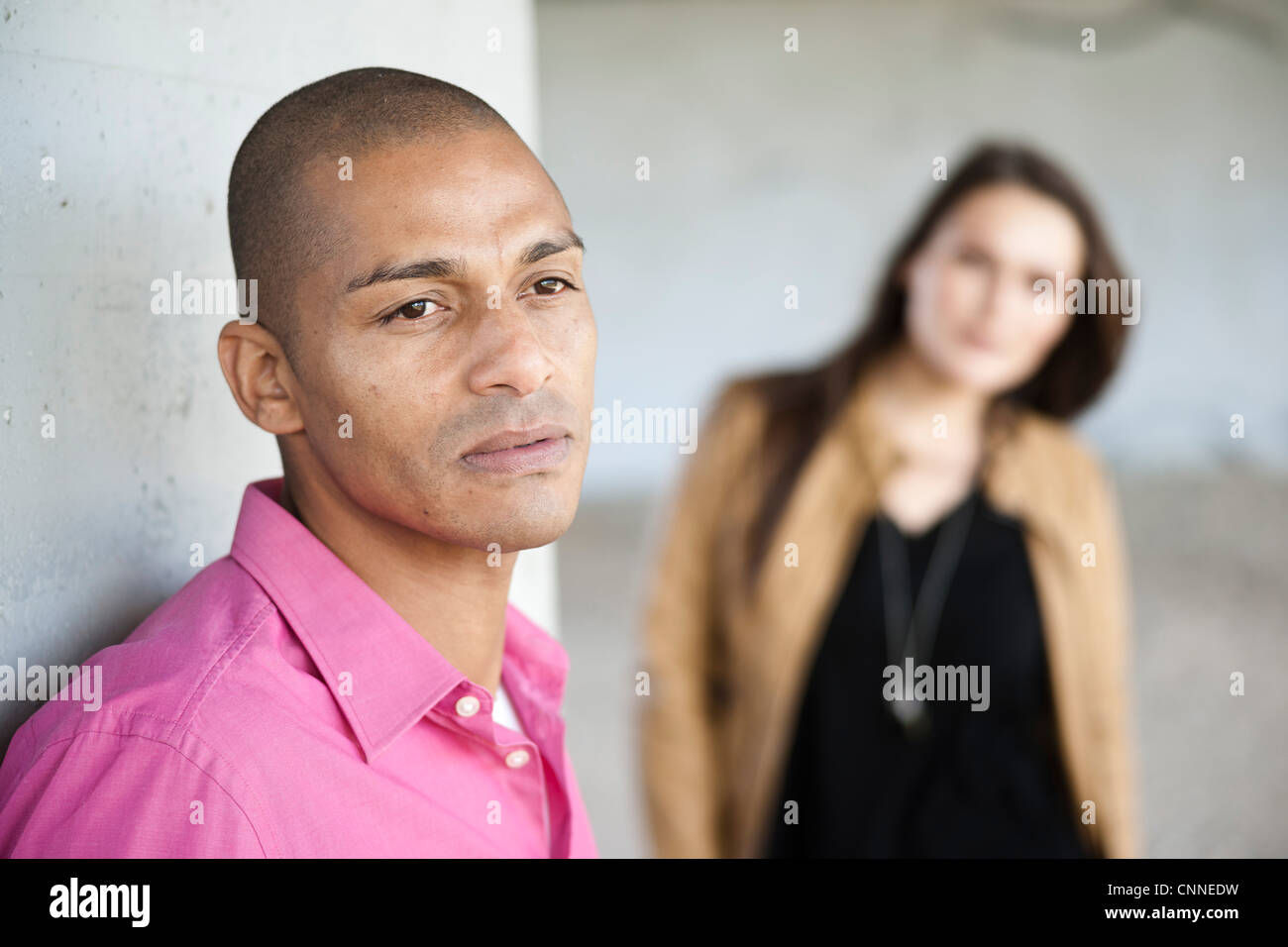 Portrait of Man with Woman in Background Stock Photo