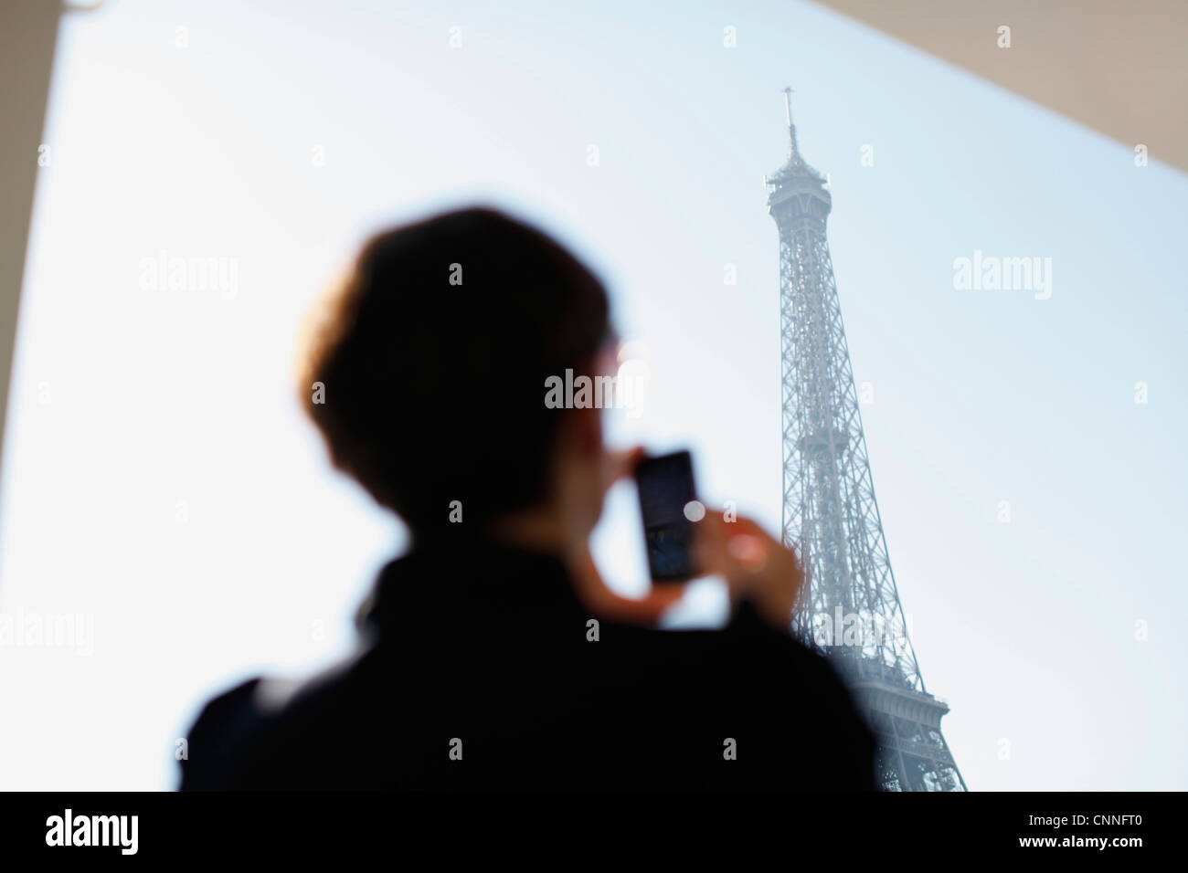 Woman taking picture of Eiffel Tower Stock Photo