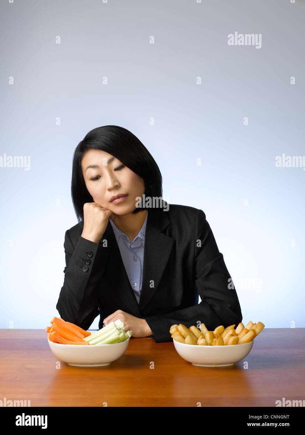 Businesswoman deciding what to eat Stock Photo - Alamy