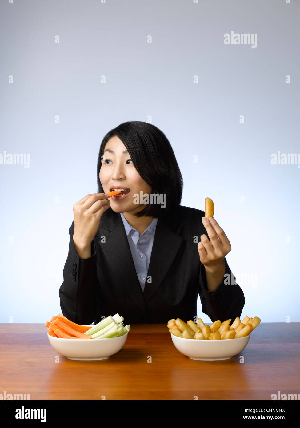 Businesswoman deciding what to eat Stock Photo