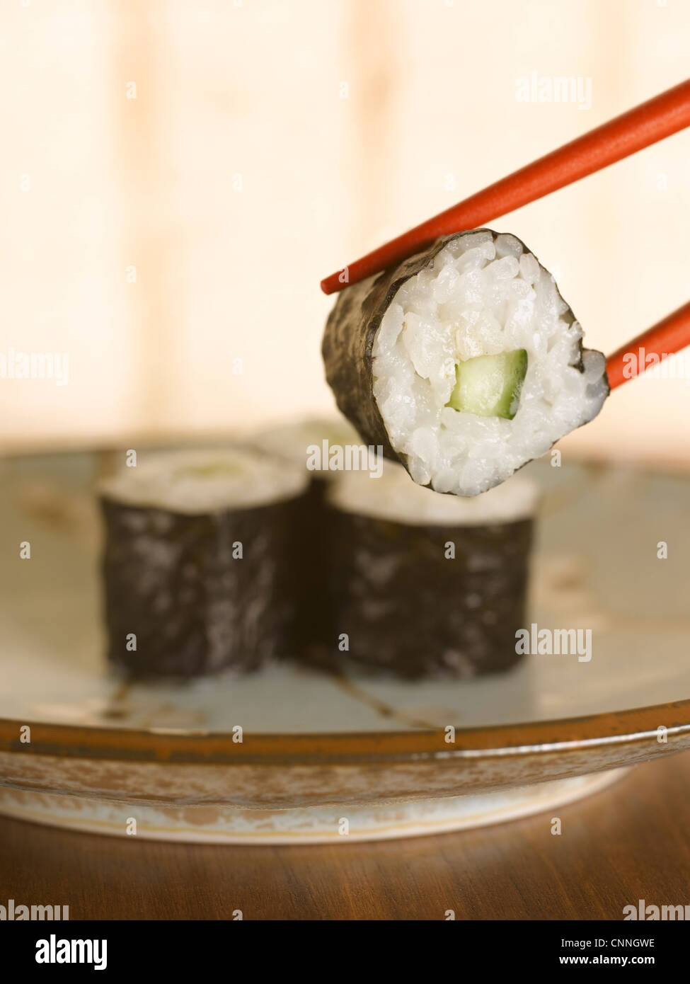 Close up of chopsticks holding sushi Stock Photo Alamy