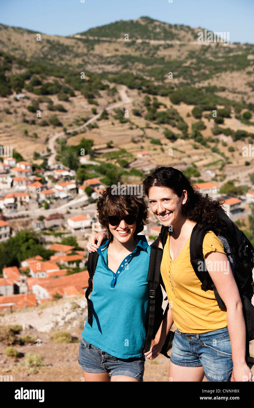 Women smiling together on hill Stock Photo