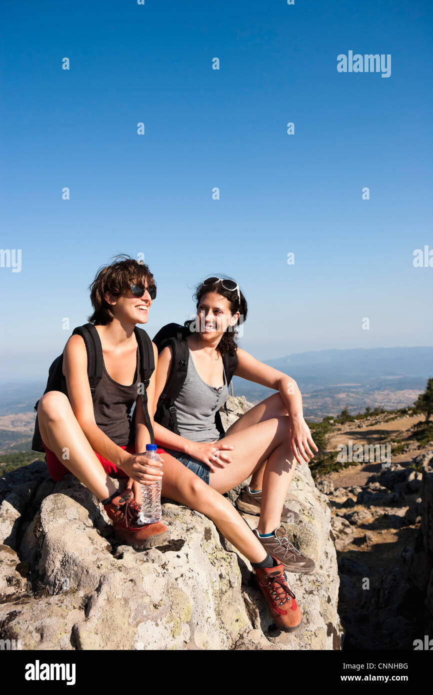 Resting On Rocks Hikers resting on rocks on hill Stock Photo - Alamy