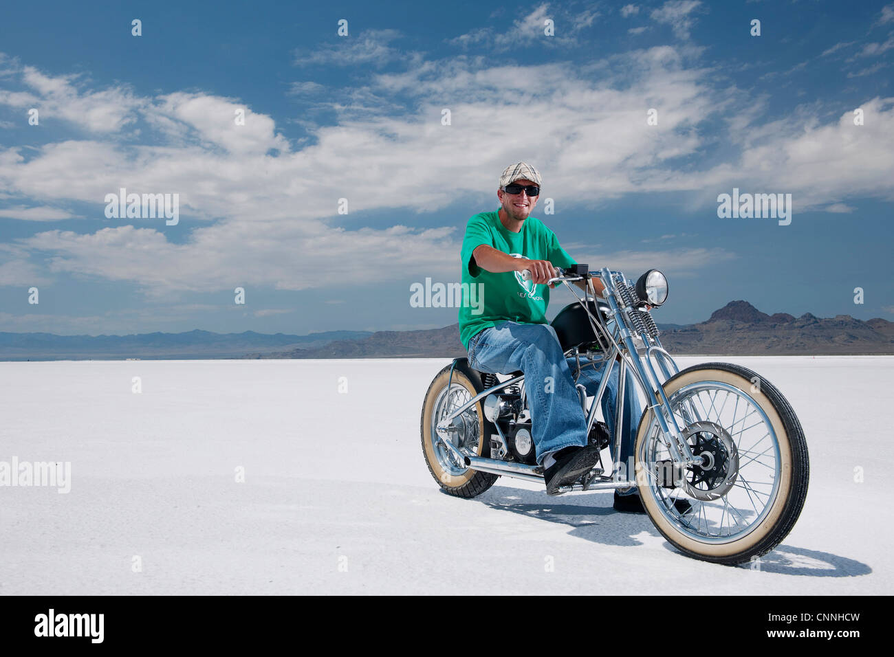 Bonneville Salt Flats bike week retro motor bike racing in USA, motor bike motorcycle parked on white salt flats green t-shirt Stock Photo