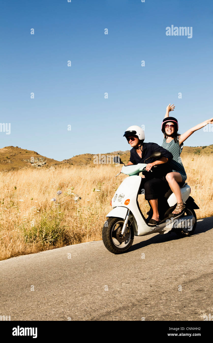 Women driving scooter on rural road Stock Photo Alamy