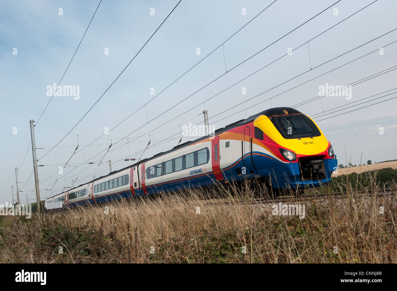 East Midlands trains class 222 meridian train speeding through the English countryside in summer. Stock Photo