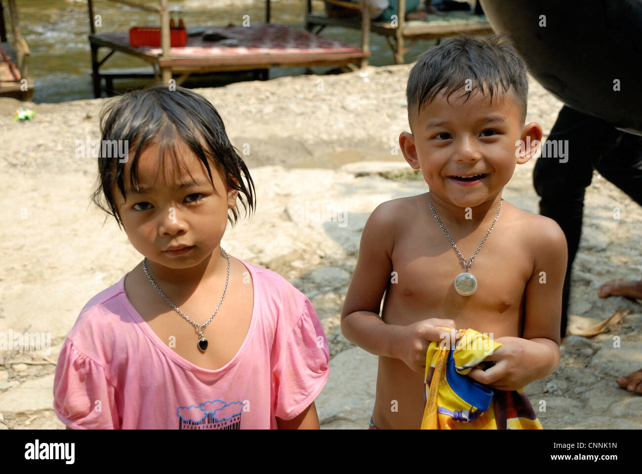 Children throwing cold water at each other on a very hot day on 3/04