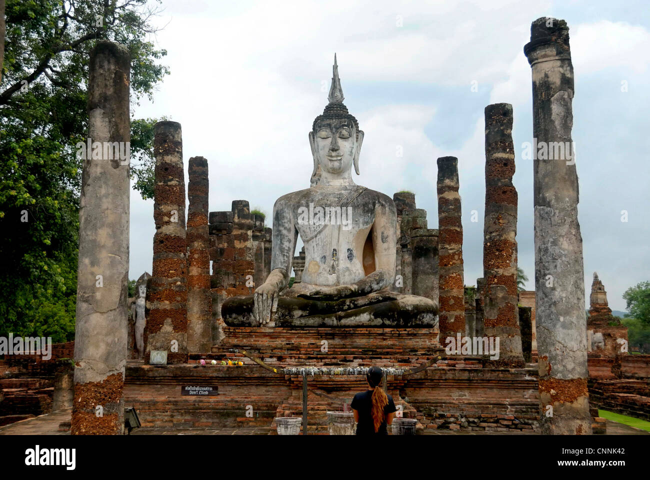 Tourist praying to Budha in Sukhothai on 25/06/2011 in Sukhothai Thailand Stock Photo