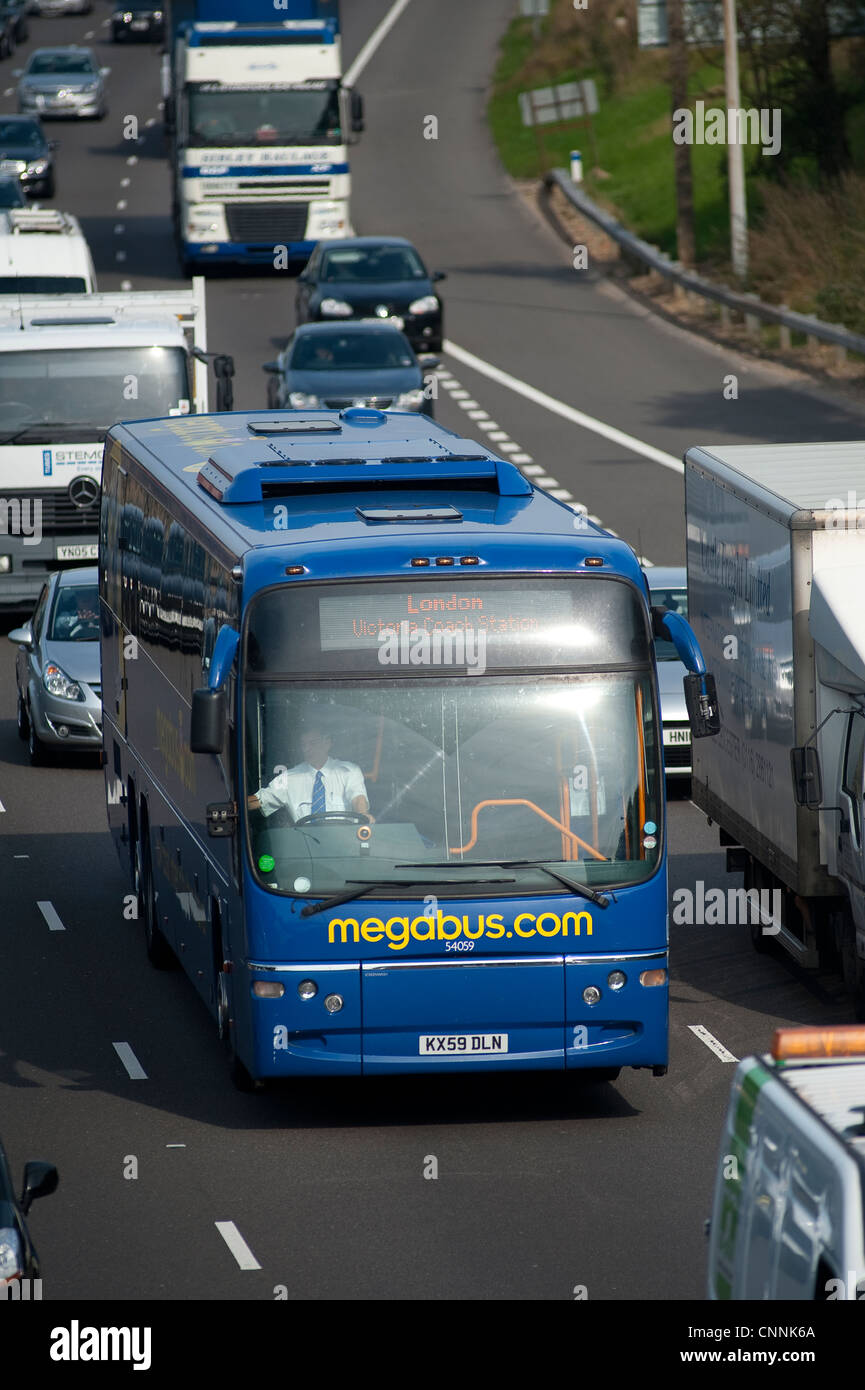 Bus travelling in heavy traffic on a motorway during rush hour in