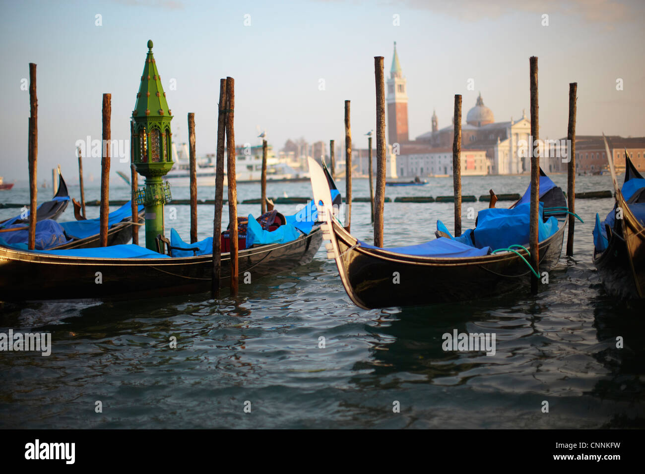 Gondolas docked at urban pier Stock Photo