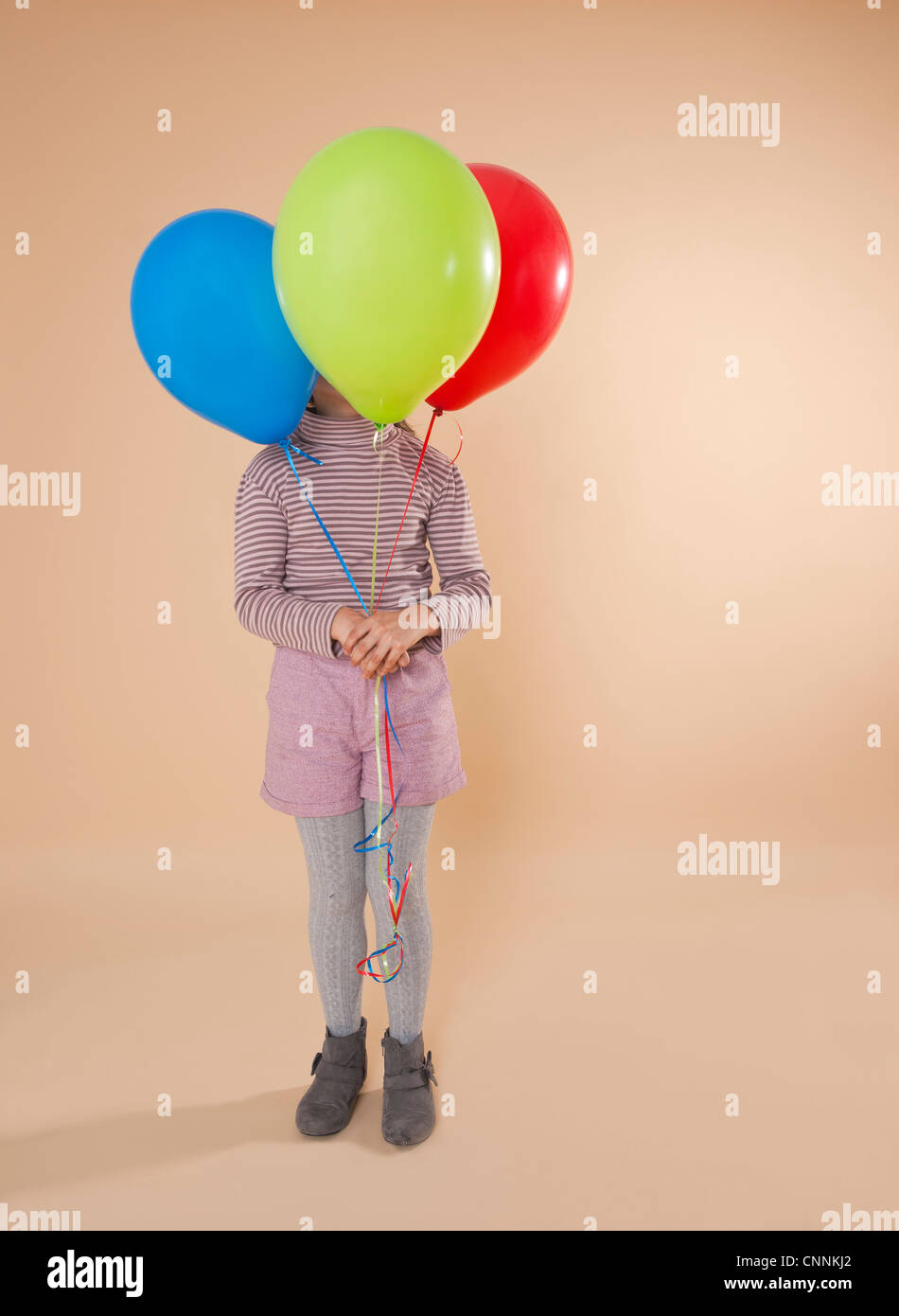 Girl Holding Balloons Stock Photo Alamy