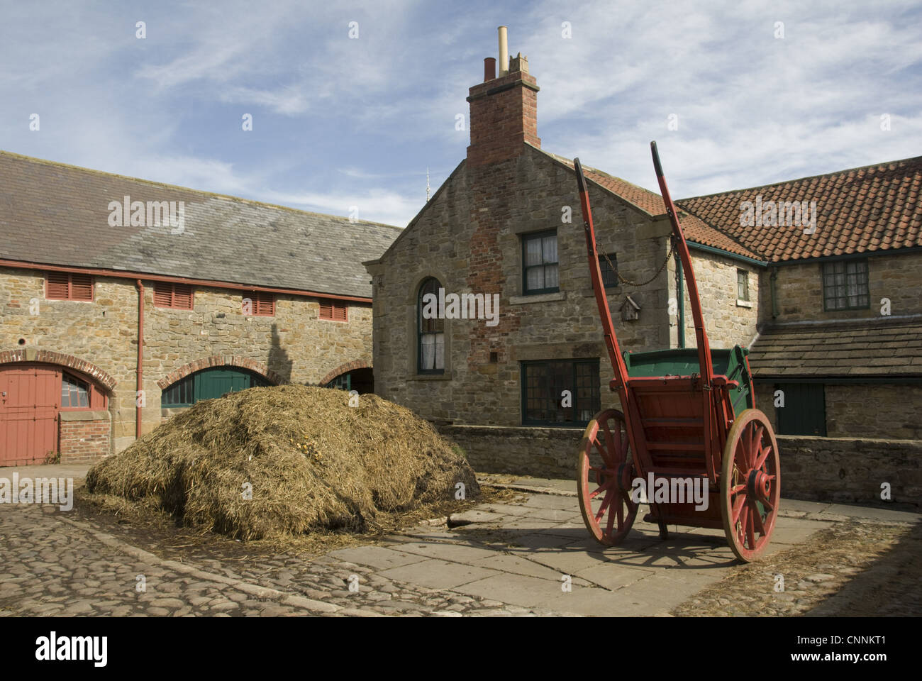 Manure heap and cart in farmyard, 1913 Home Farm, Beamish Museum