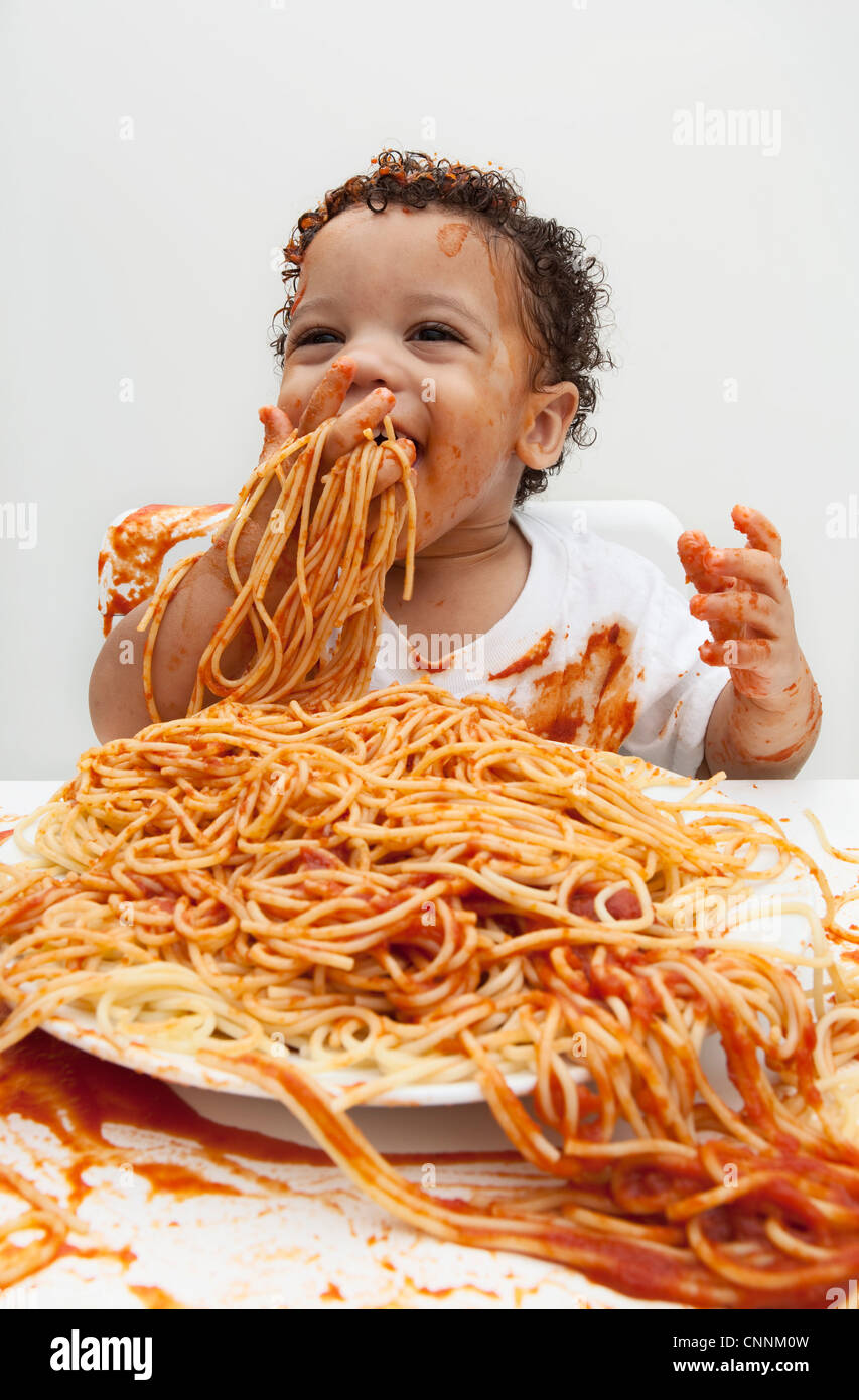 Boy eating Spaghetti with Hands Stock Photo Alamy