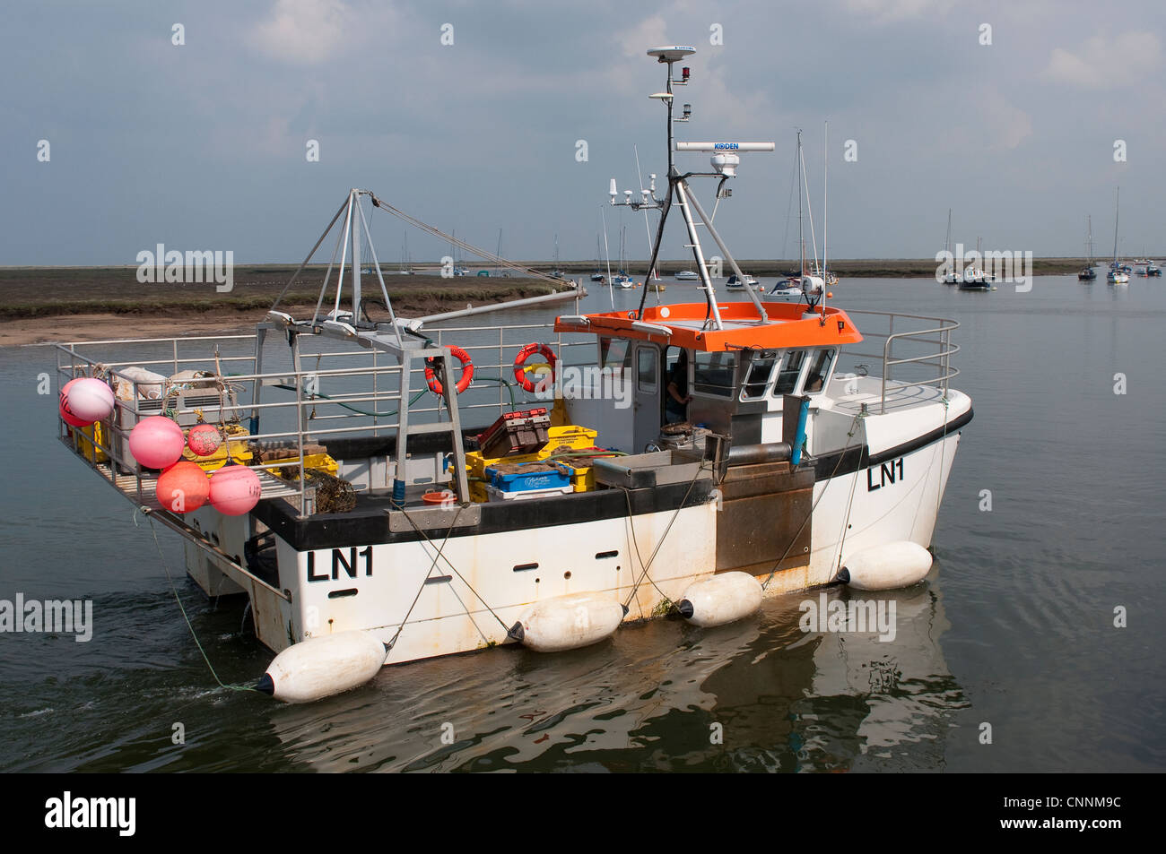 Fishing boat leaving the harbour at Wells Next The Sea, Norfolk, East