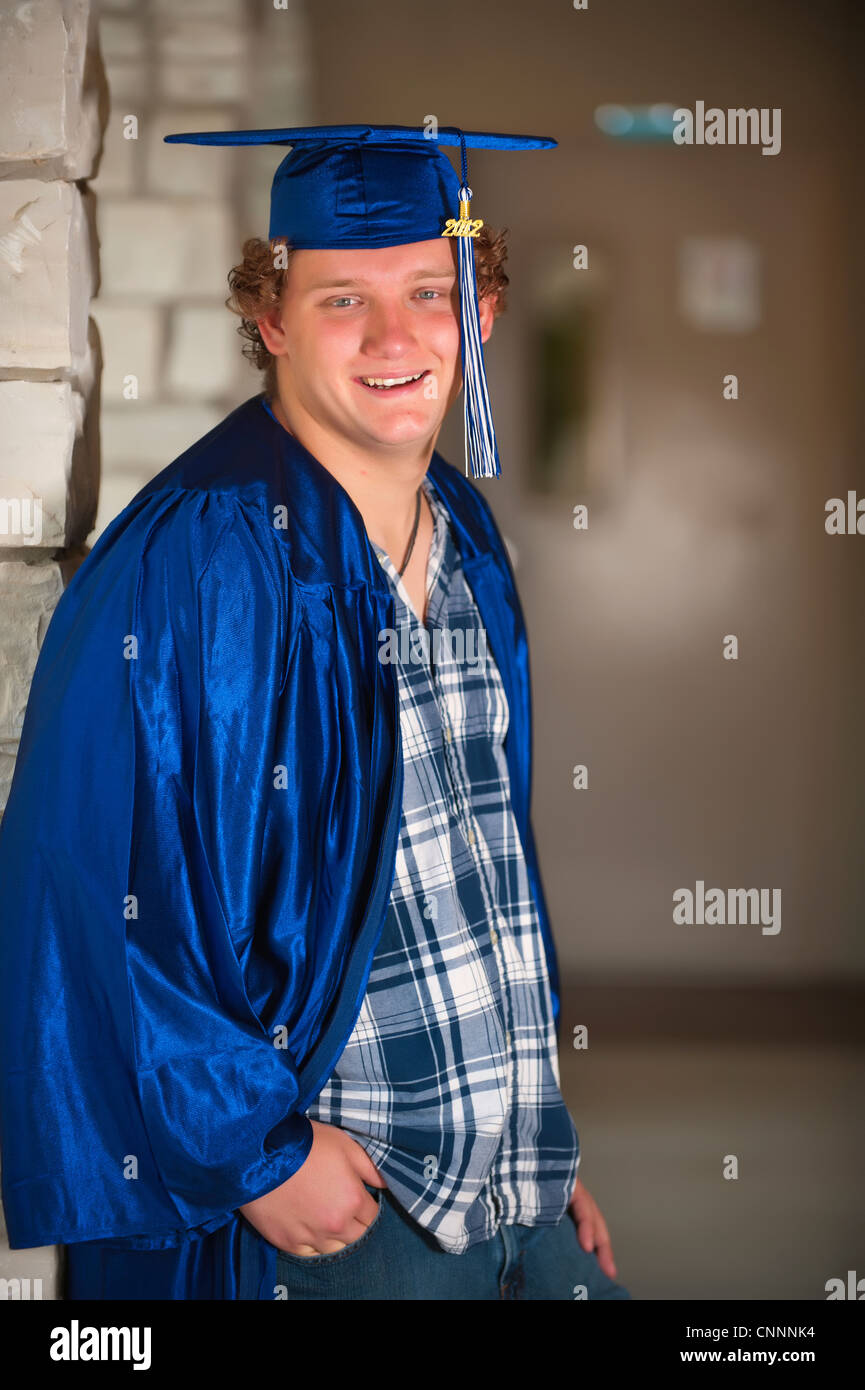 Male high school student in graduation outfit on school campus Stock Photo  - Alamy