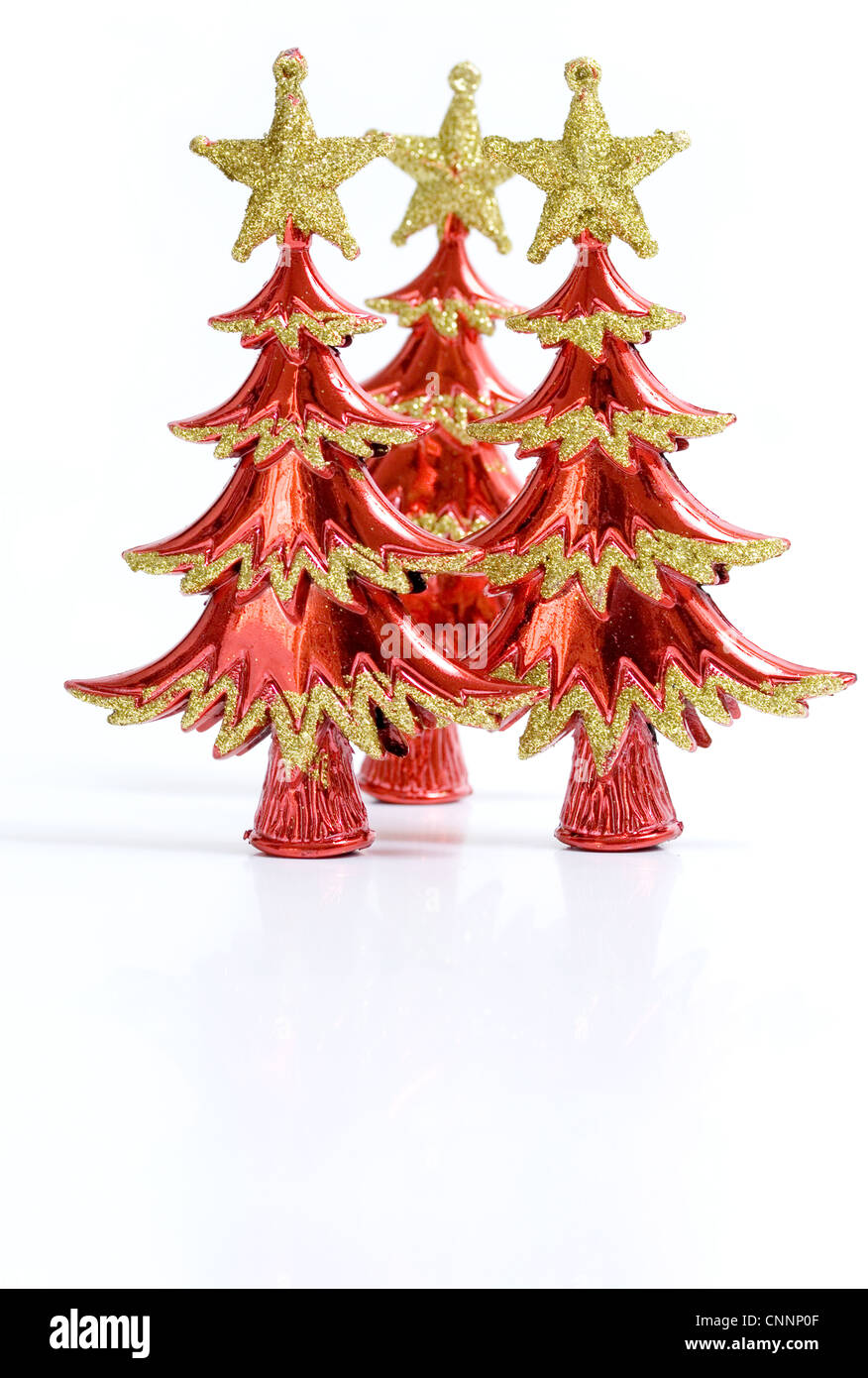 Three red and gold ornamental Christmas Tree cut outs. Stock Photo