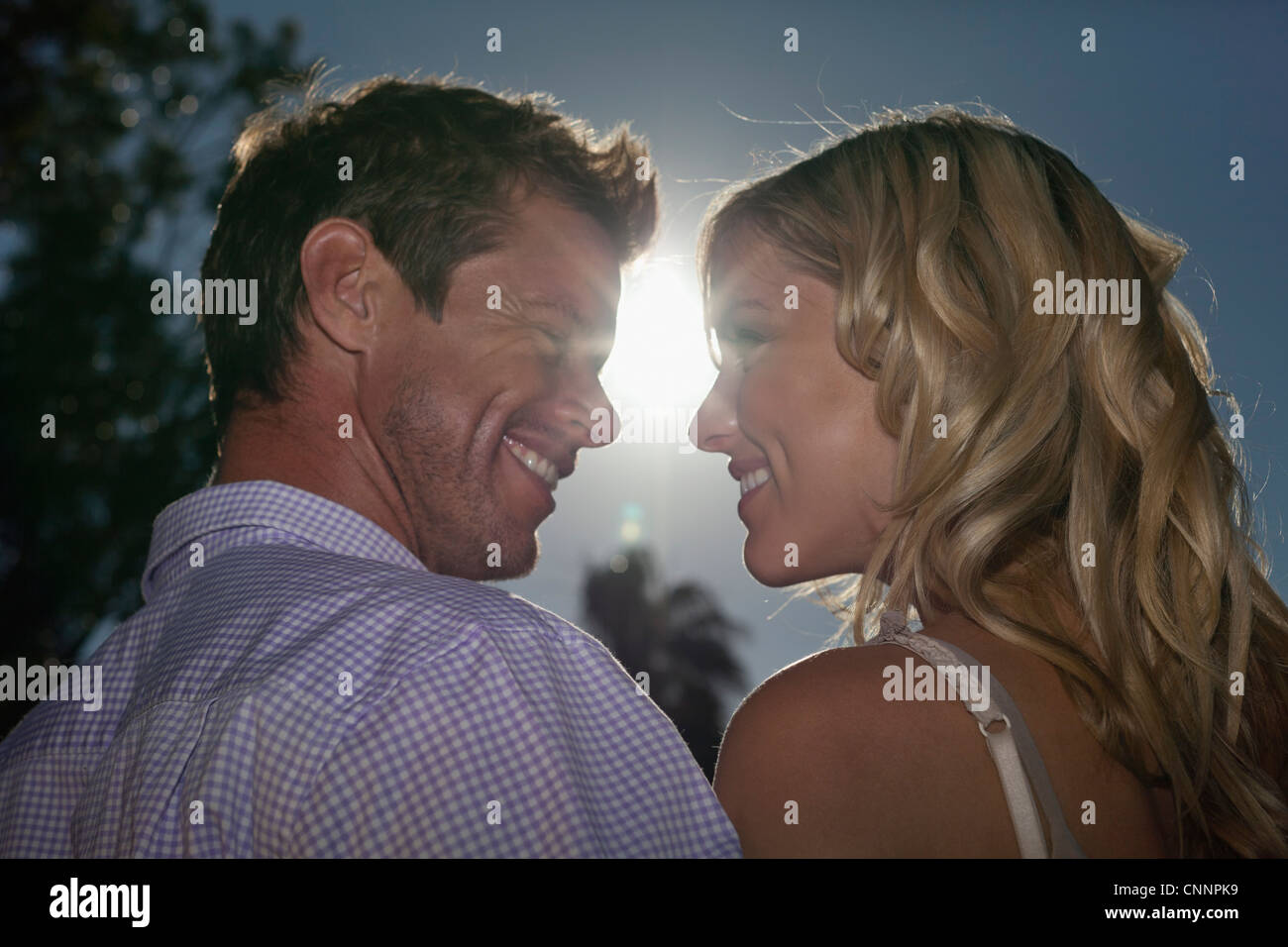 Couple smiling at each other outdoors Stock Photo