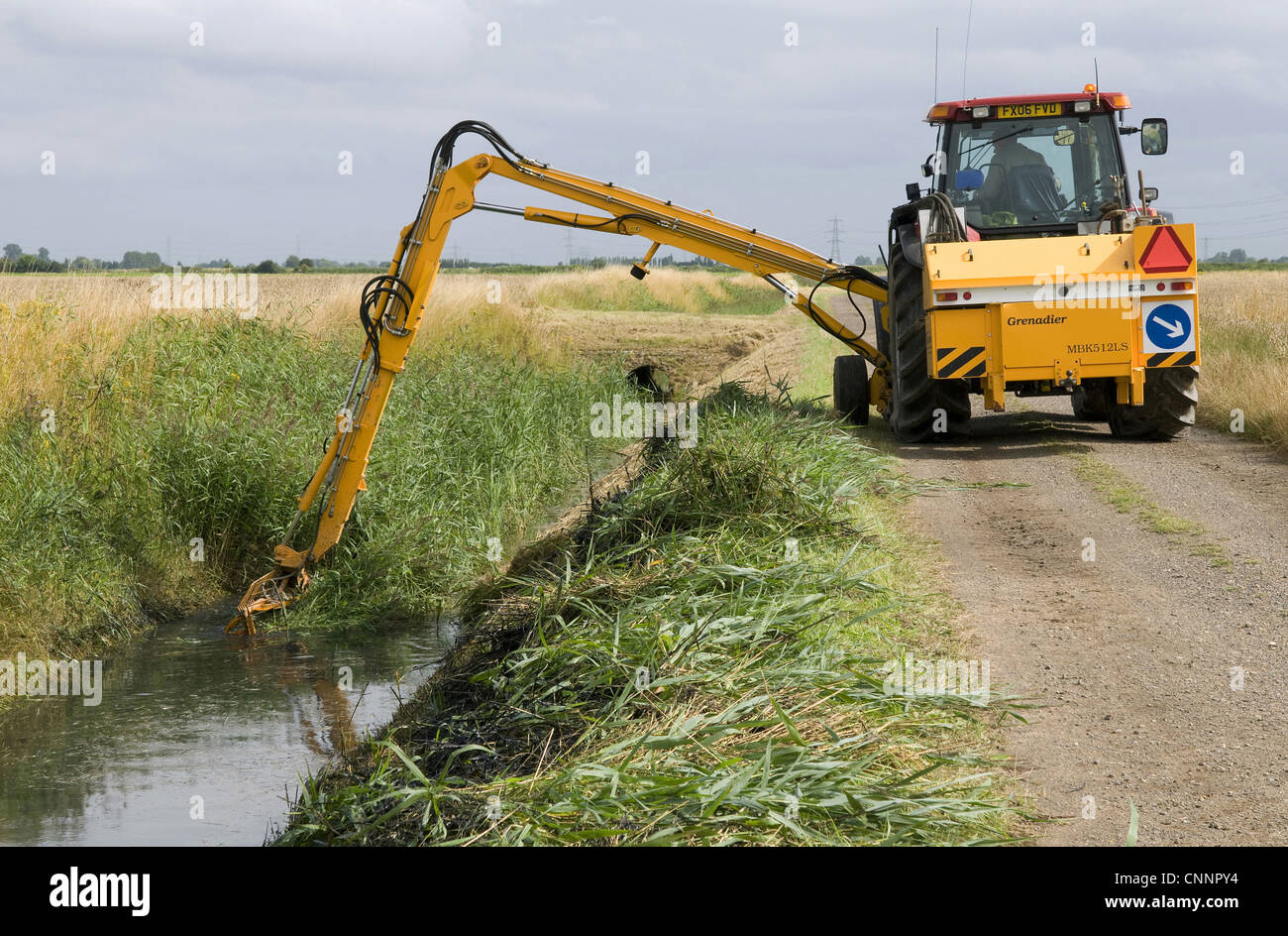 Tractor boom arm clearing reed overgrown dyke countryside management