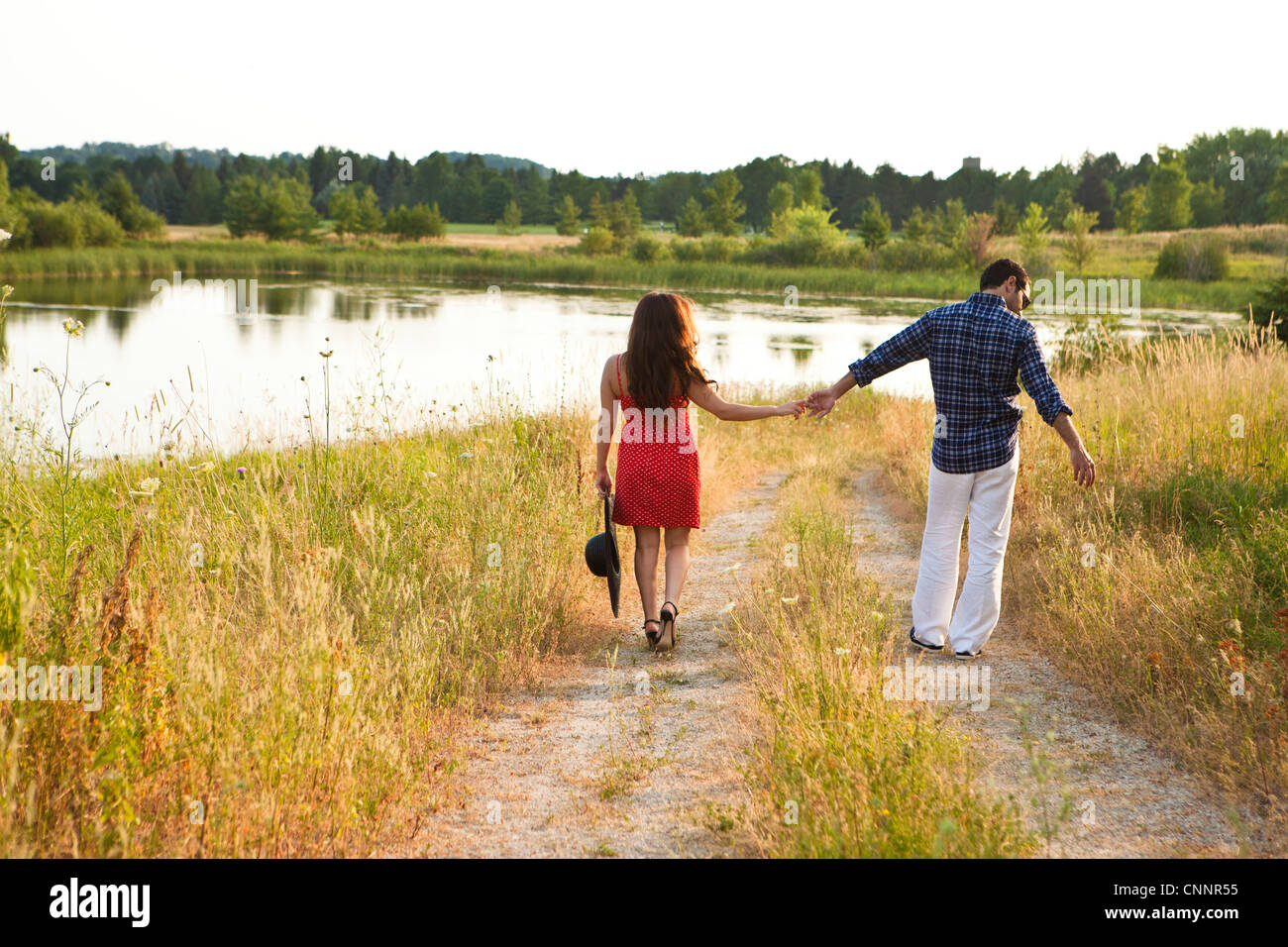 Couple Walking by Pond, Unionville, Ontario, Canada Stock Photo