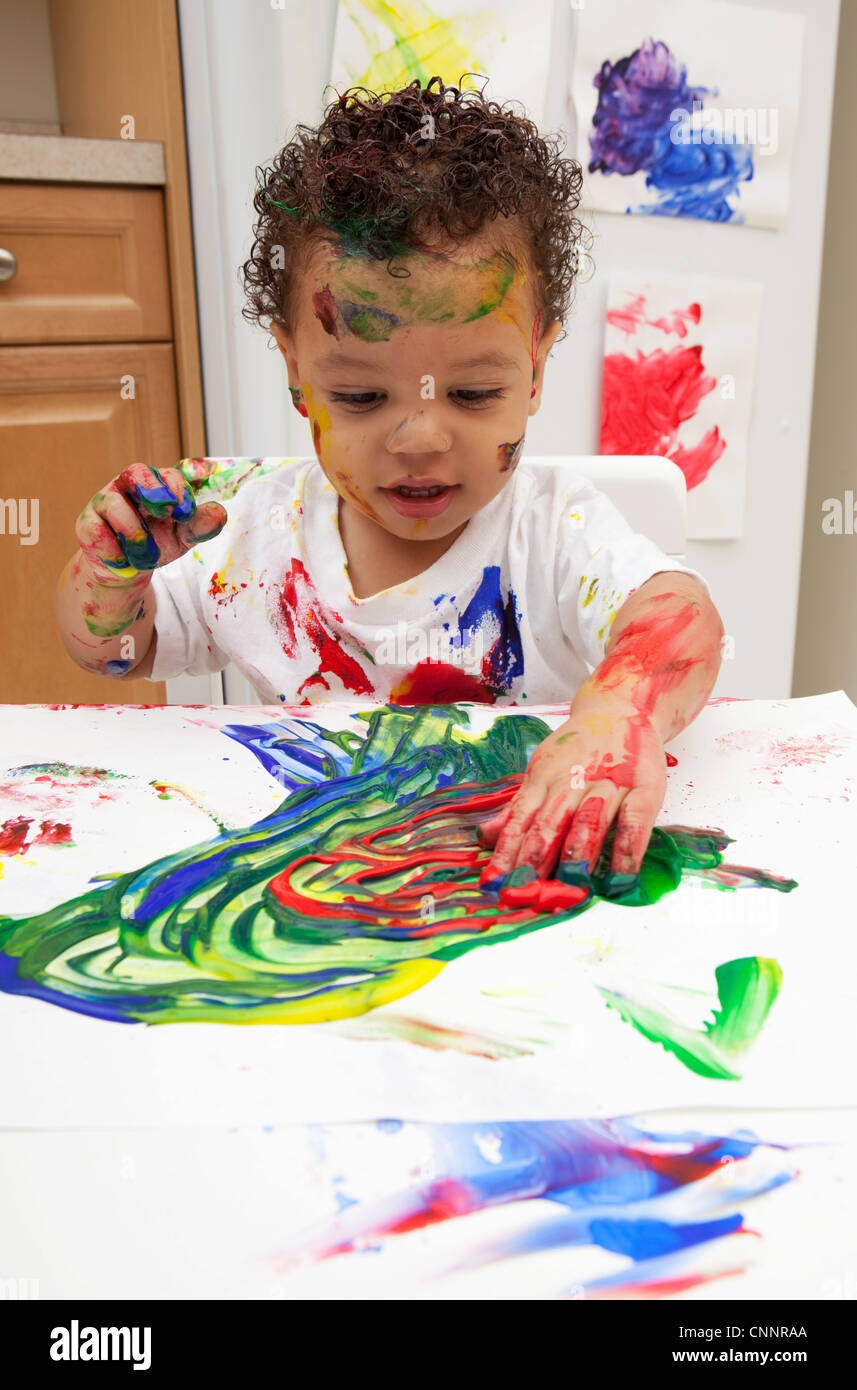 a child painting with finger paints, Stock image